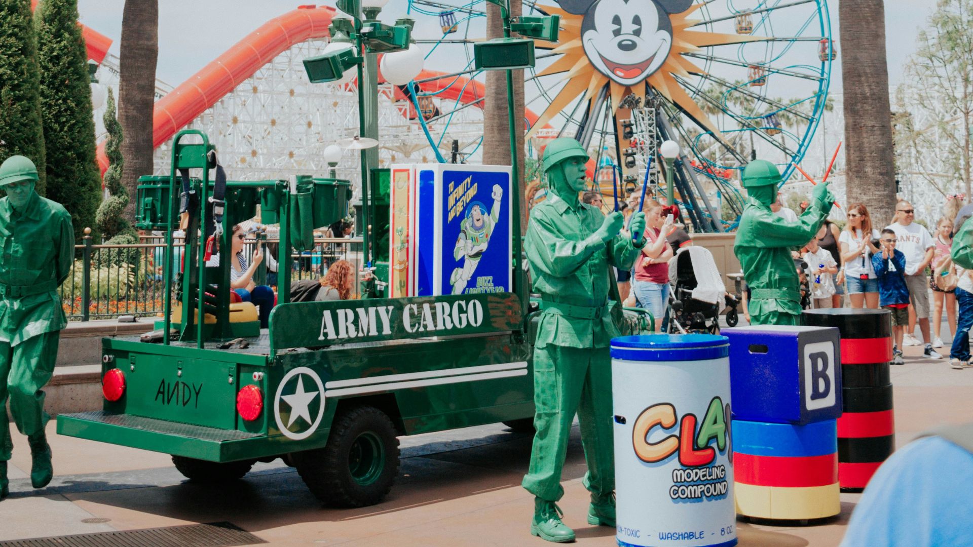 Green Army Men from Toy Story performing Operation: Playtime in Disney California Adventure Park, near the Pixar Pier, with the Mickey's Fun Wheel Ferris wheel in the background.