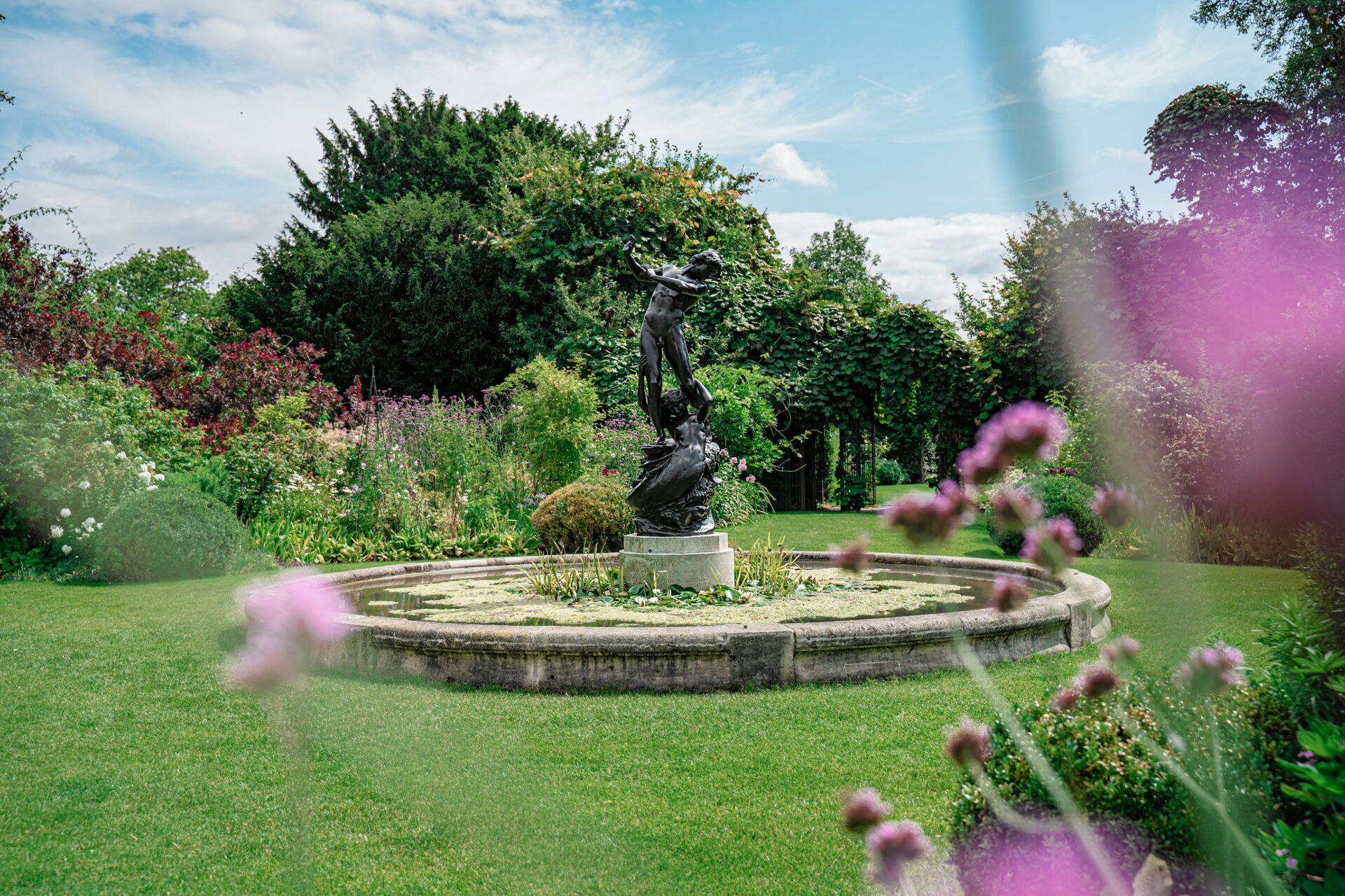 Elegant sculptural fountain in Regent’s Park, featuring classical figures surrounded by landscaped gardens and greenery.