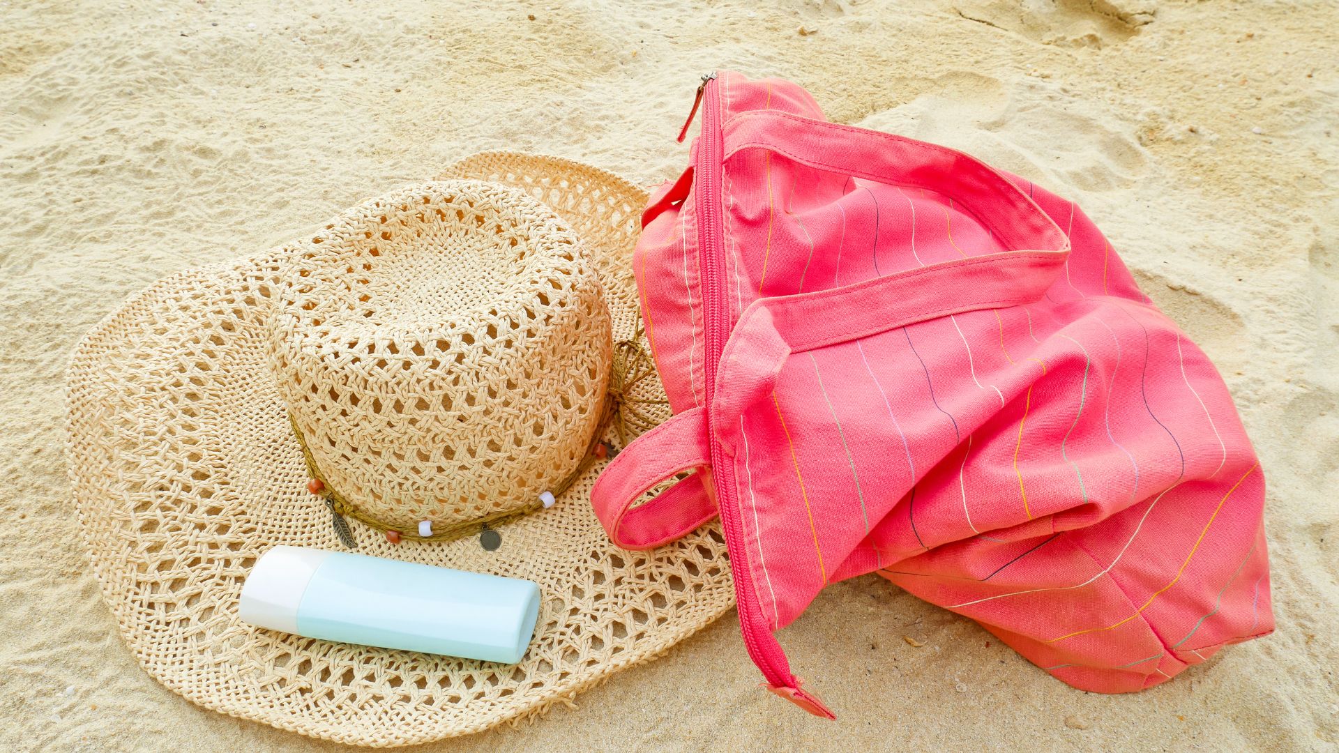 A hat, red bag, and sunblock. 