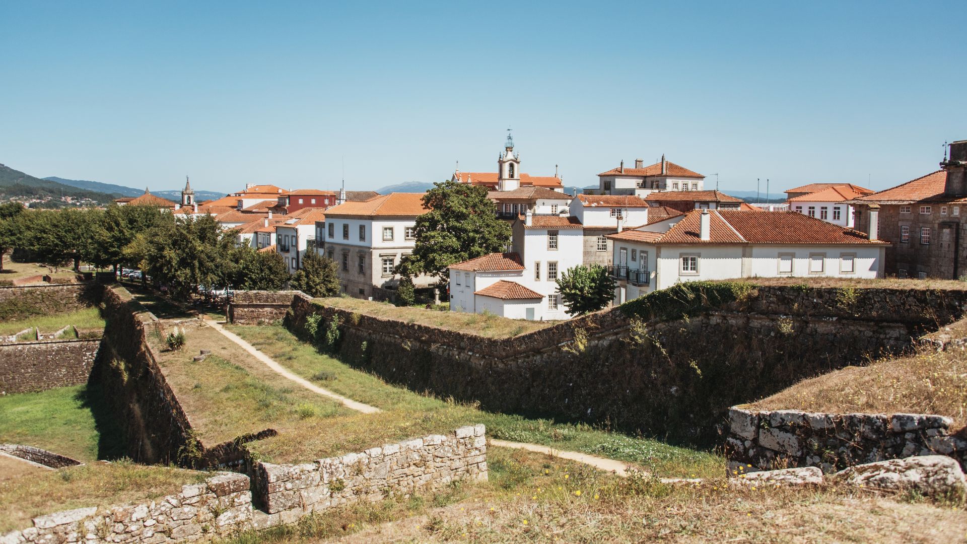 A view of the historic Fortaleza de Valença in Portugal, showcasing its stone walls and the town within, under a clear sky.