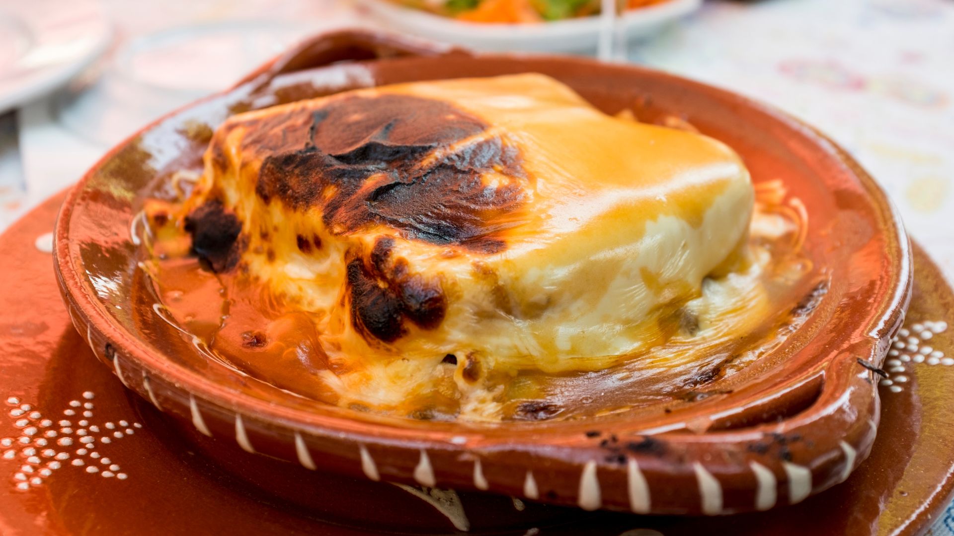 Francesinha -  a stacked sandwich oozing with melted cheese and spicy sauce