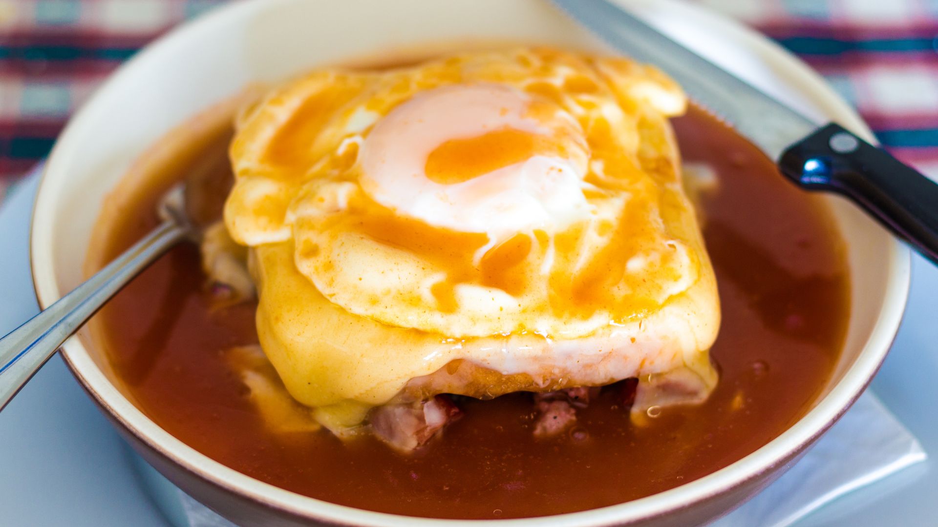 Francesinha -  a stacked sandwich oozing with melted cheese and spicy sauce