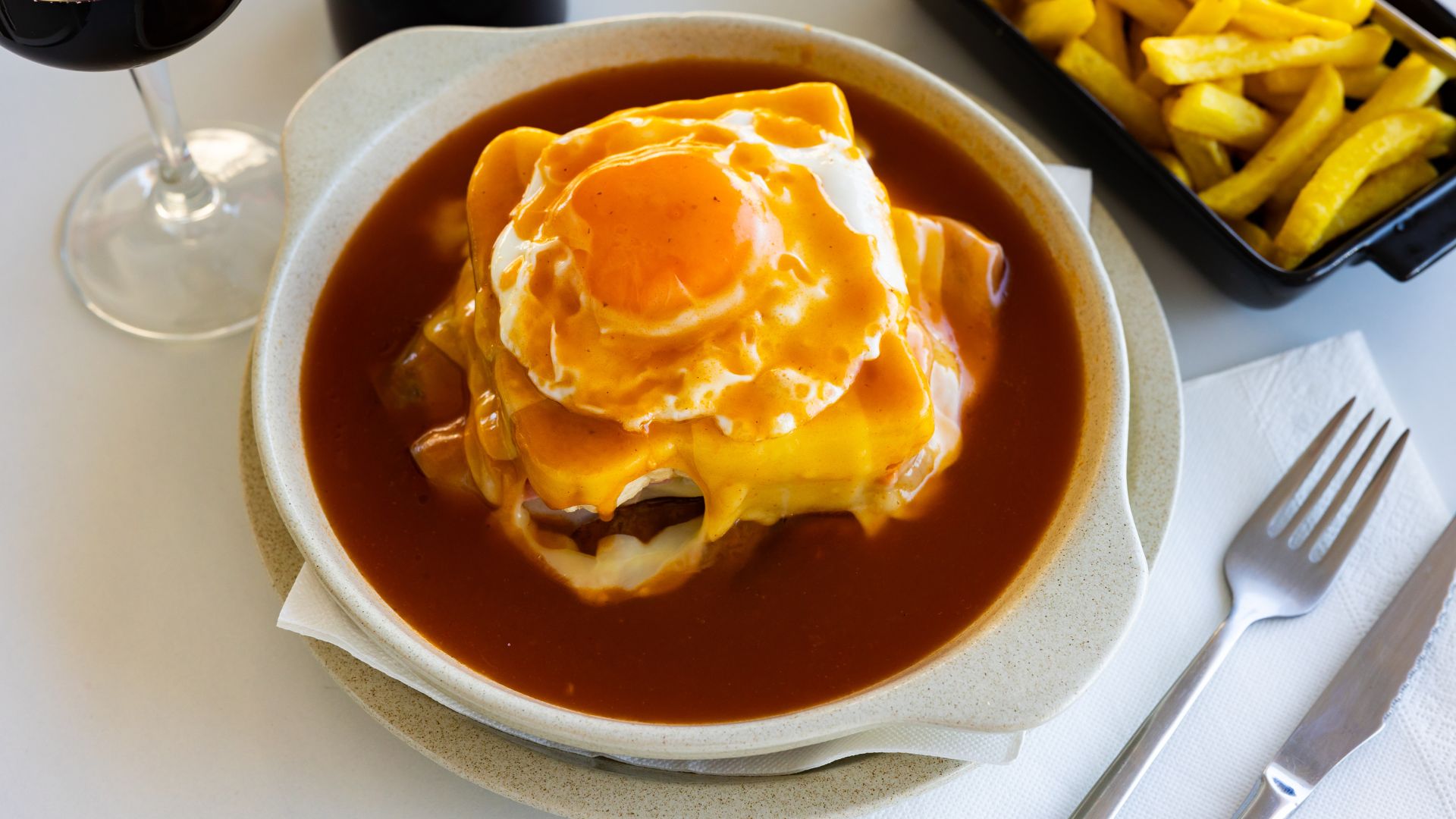 Francesinha -  a stacked sandwich oozing with melted cheese and spicy sauce