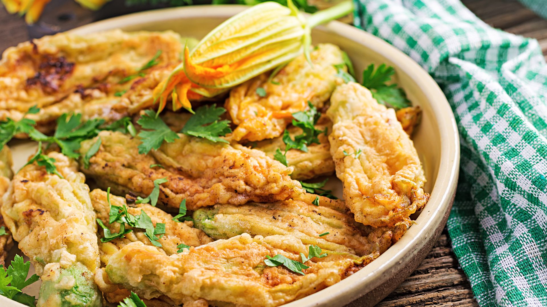 Fried Zaucchini blossoms on a plate.