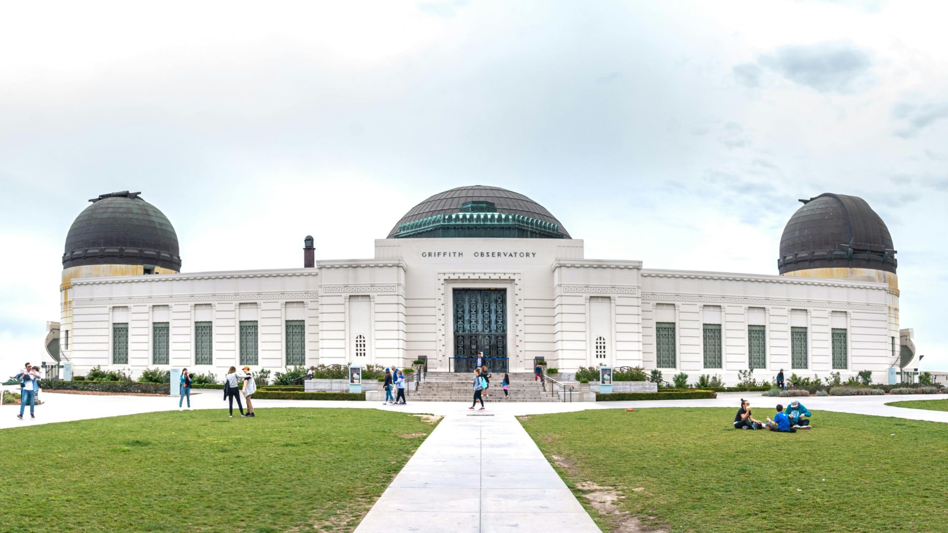 Close up look of the Griffith Observatory in Los Angeles, California, showcasing the iconic building, and surrounding green lawns
