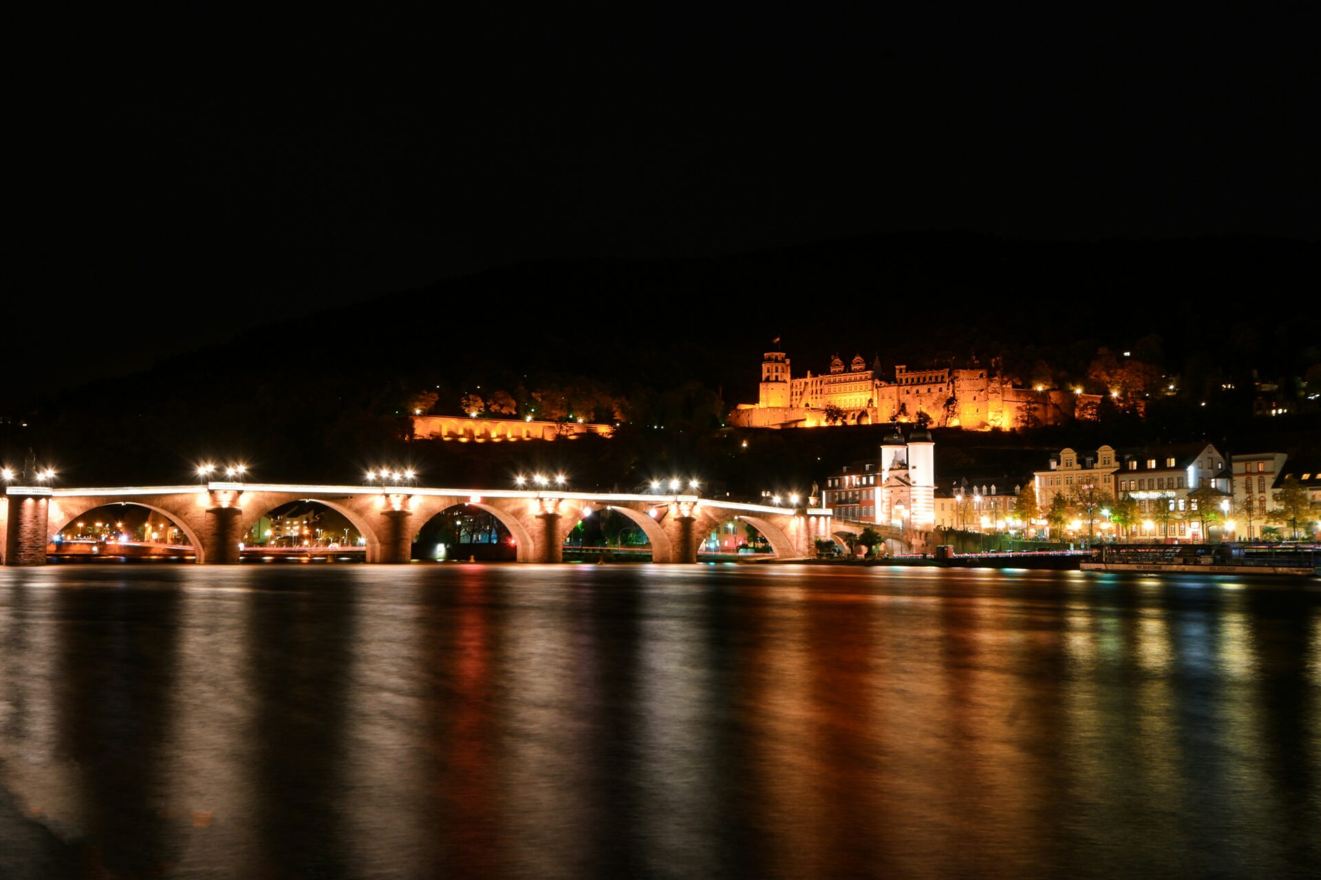 Heidelberg’s old town glows under the night sky