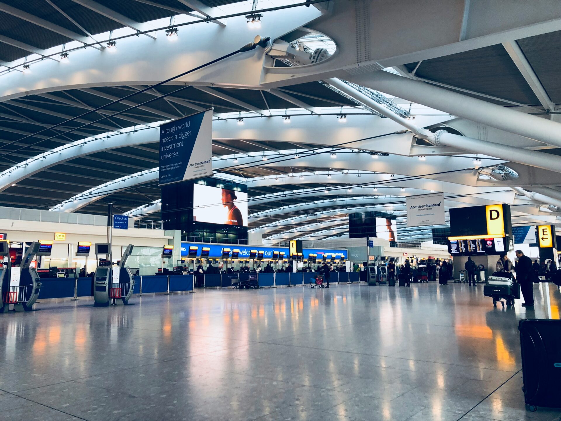 Inside Heathrow Airport, with passengers walking through the terminal