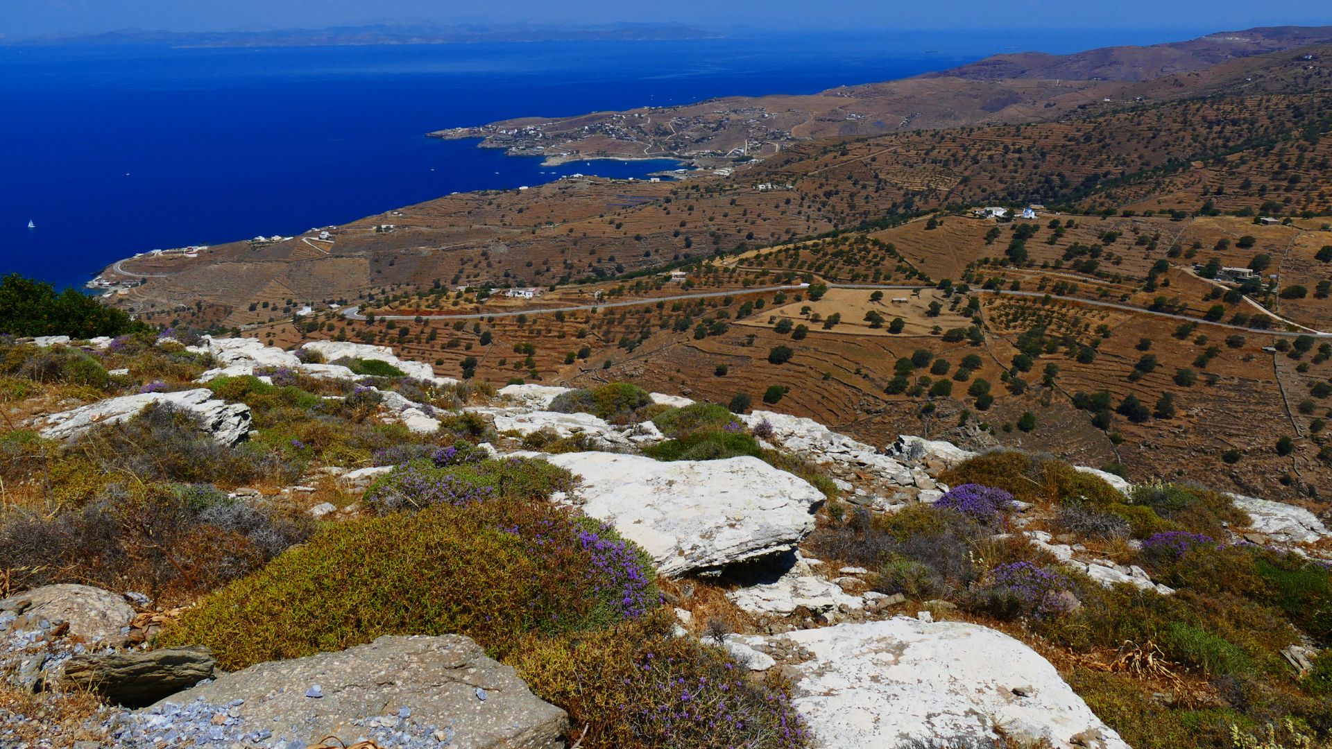 Scenic view of Kea, Greece, showing terraced hills and the Aegean Sea.