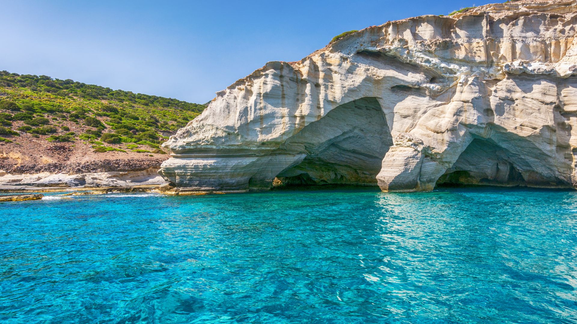 Turquoise water, rock formations, and white cliffs at Kleftiko Beach in Milos, Greece.