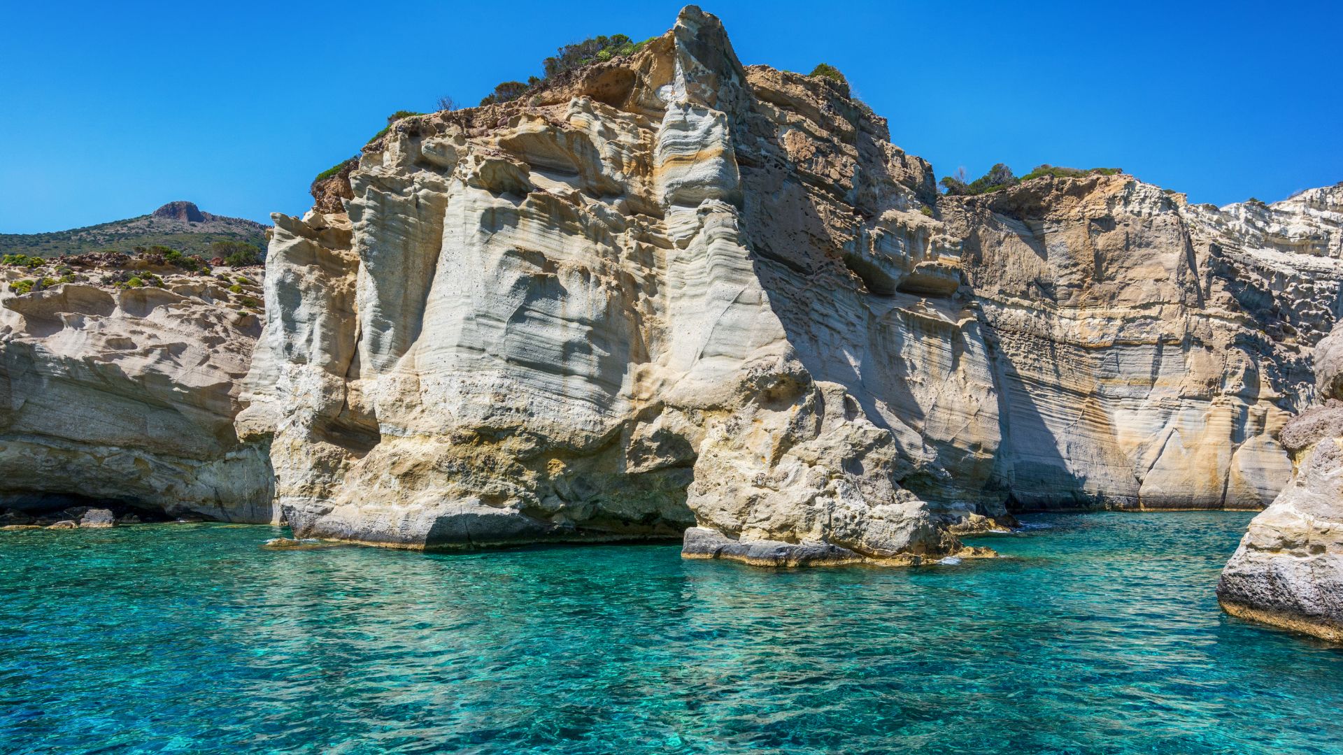 Turquoise water, rock formations, and white cliffs at Kleftiko Beach in Milos, Greece.