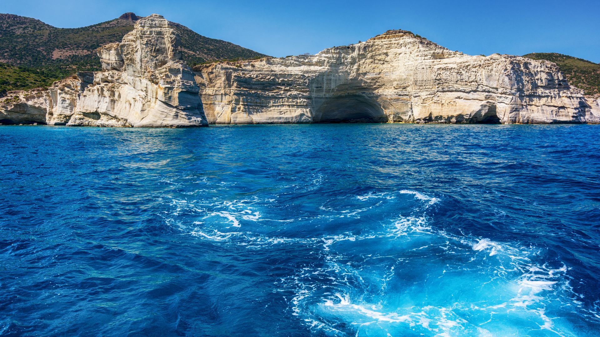 Turquoise waters and white cliffs at Kleftiko Beach in Milos, Greece.