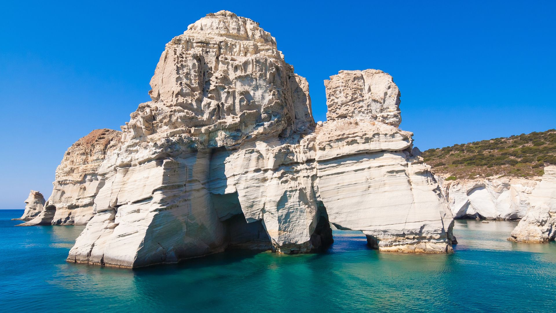 Turquoise waters, rock formations,  white cliffs at Kleftiko Beach in Milos, Greece.