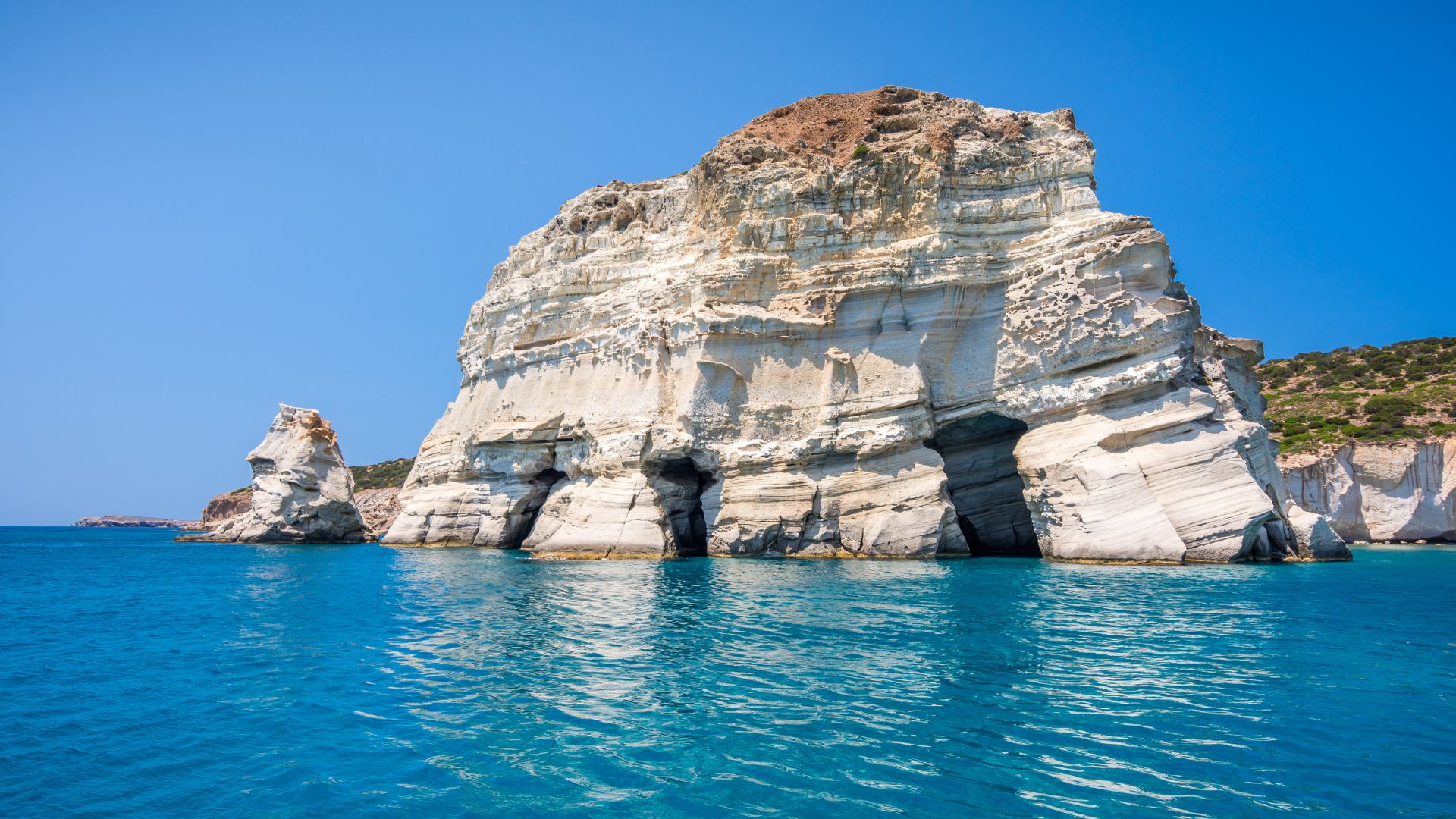 Turquoise water, rock formations, and white cliffs at Kleftiko Beach in Milos, Greece.