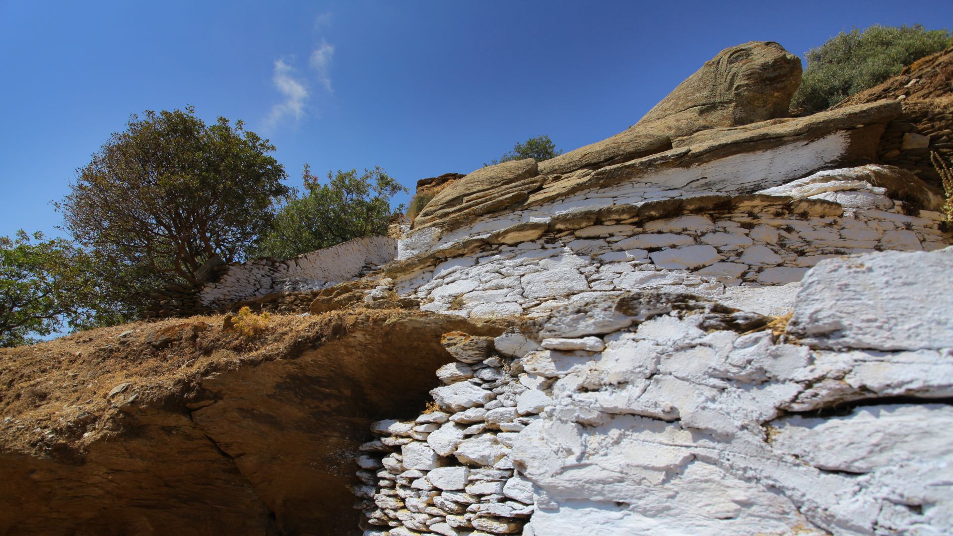 Ancient stone lion sculpture, Lion of Kea, on a Greek island, symbolizing protection and history.