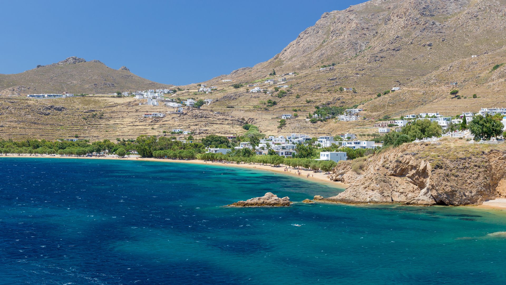 Scenic view of Livadakia Beach in Serifos, Greece, with clear turquoise waters and a sandy shore.