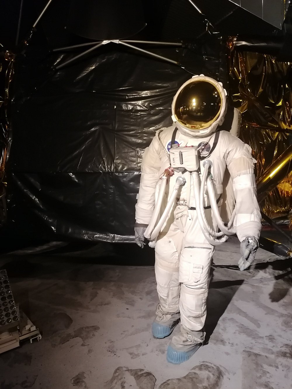 Person wearing a white astronaut suit posing inside the London Science Museum