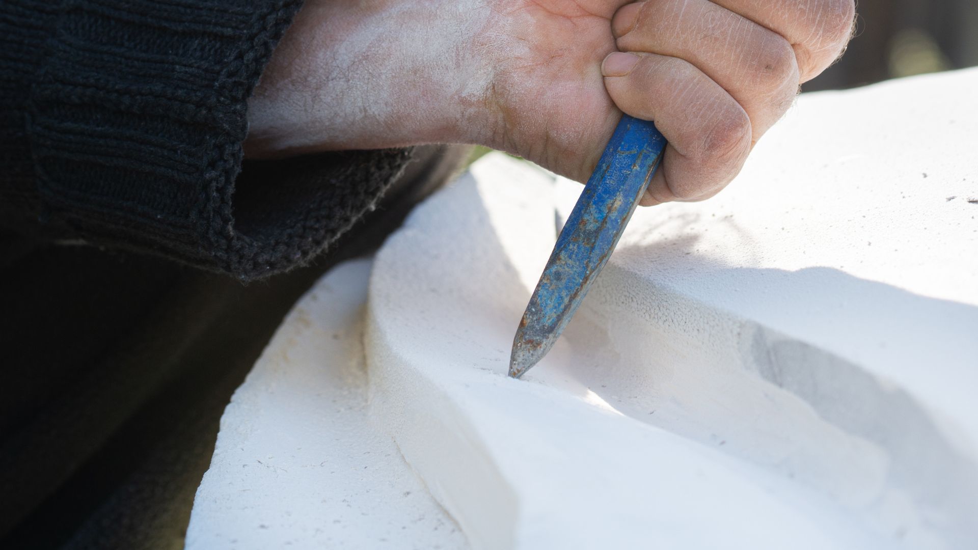 Man carving a marble