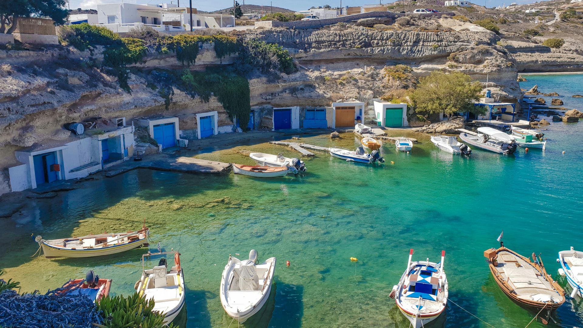 Mandrakia fishing village in Milos, Greece, with colorful boat houses.