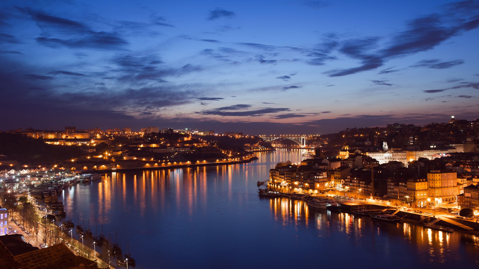A panoramic view of Porto and the Douro River from Miradouro da Serra do Pilar, with the Dom Luís I Bridge prominently featured.