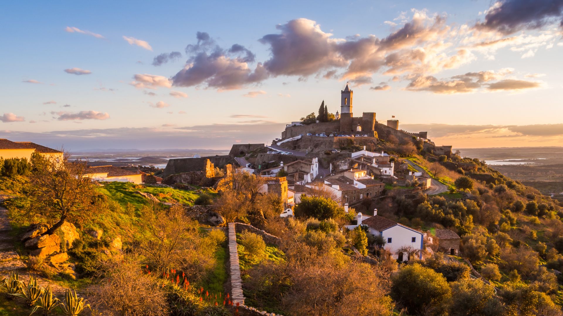 Medieval hilltop village of Monsaraz, Portugal, at sunset, overlooking the Alqueva Lake in the Alentejo region.