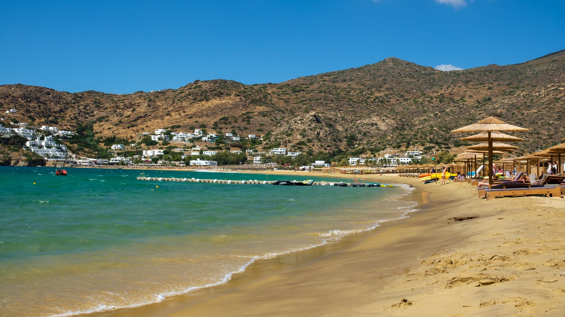 Mylopotas Beach, Ios, Greece, with golden sand and clear water.