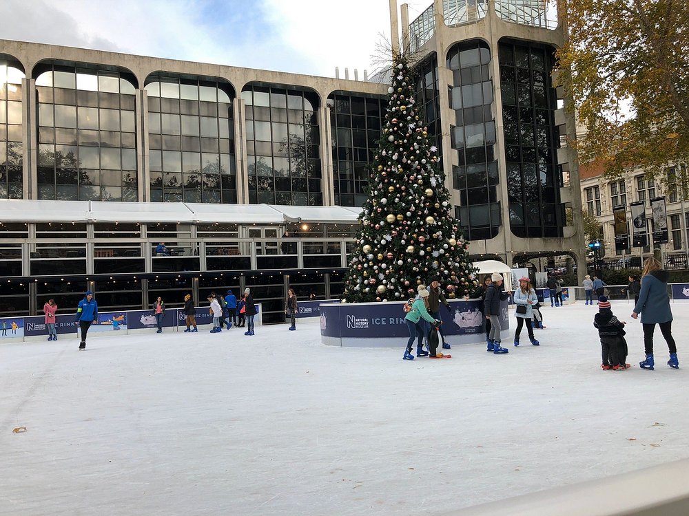 Skaters and holiday lights near historic museum 
