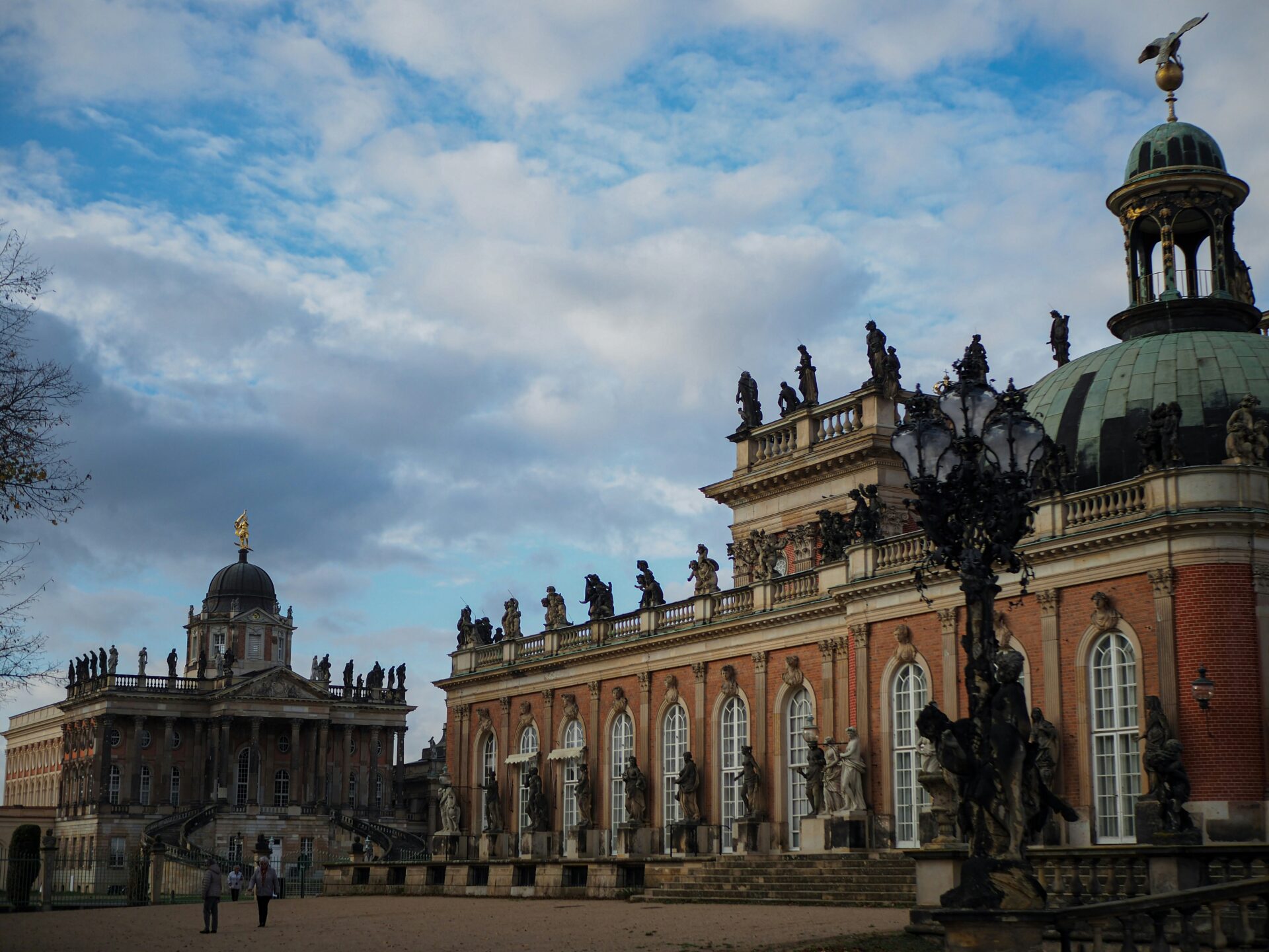 Wide-angle shot of the Neues Palais with its red-brick facade