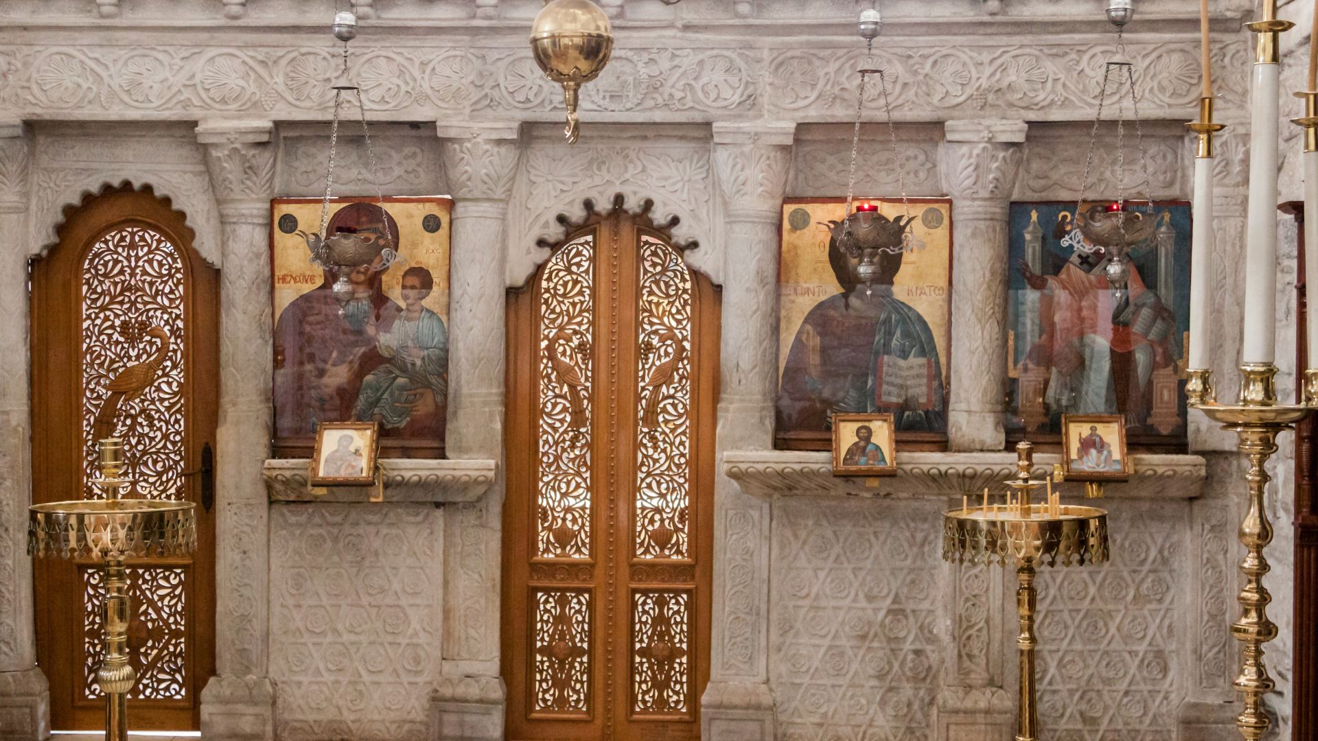 Interior view of the Panagia Ekatontapiliani Church in Paros, Greece, featuring religious icons and ornate doorways.