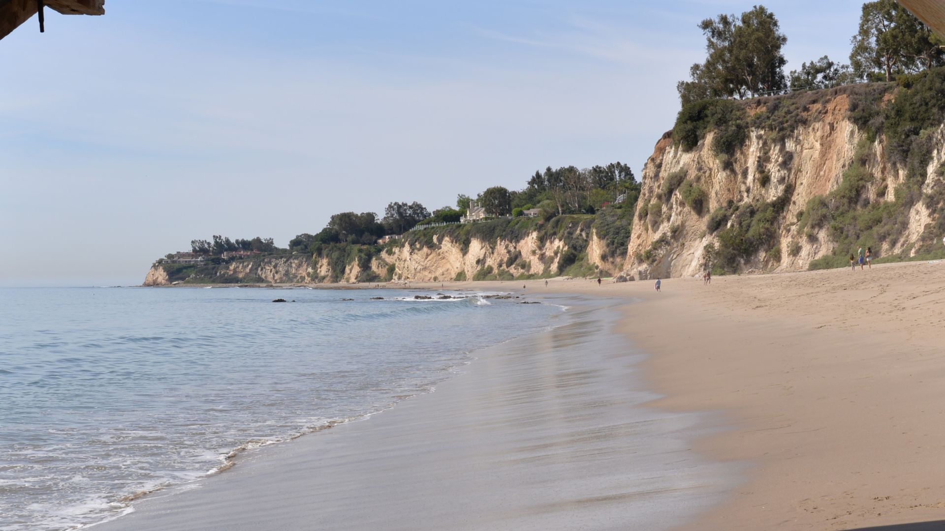 Paradise Cove Beach Malibu California with sandy shore, ocean waves, and scenic cliffs under a clear sky