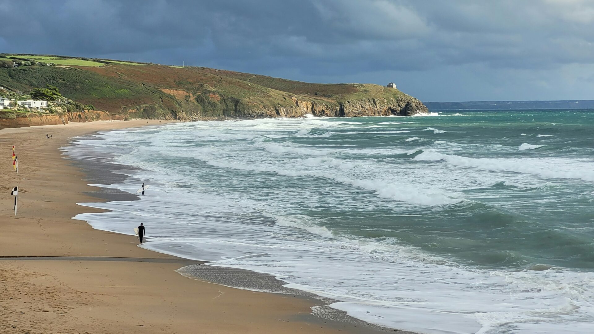 Peaceful scene of people enjoying a walk on the beach at St Ives