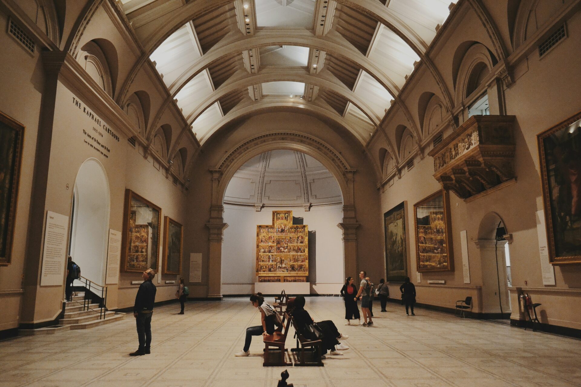 People walking around a room of artwork in the Victoria and Albert Museum