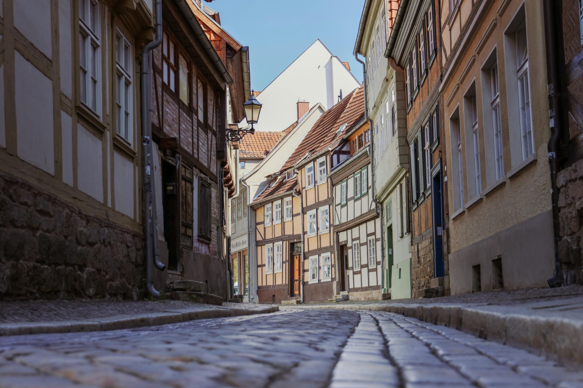 Picturesque cobblestone street lined with colorful half-timbered houses in a historic Altstadt