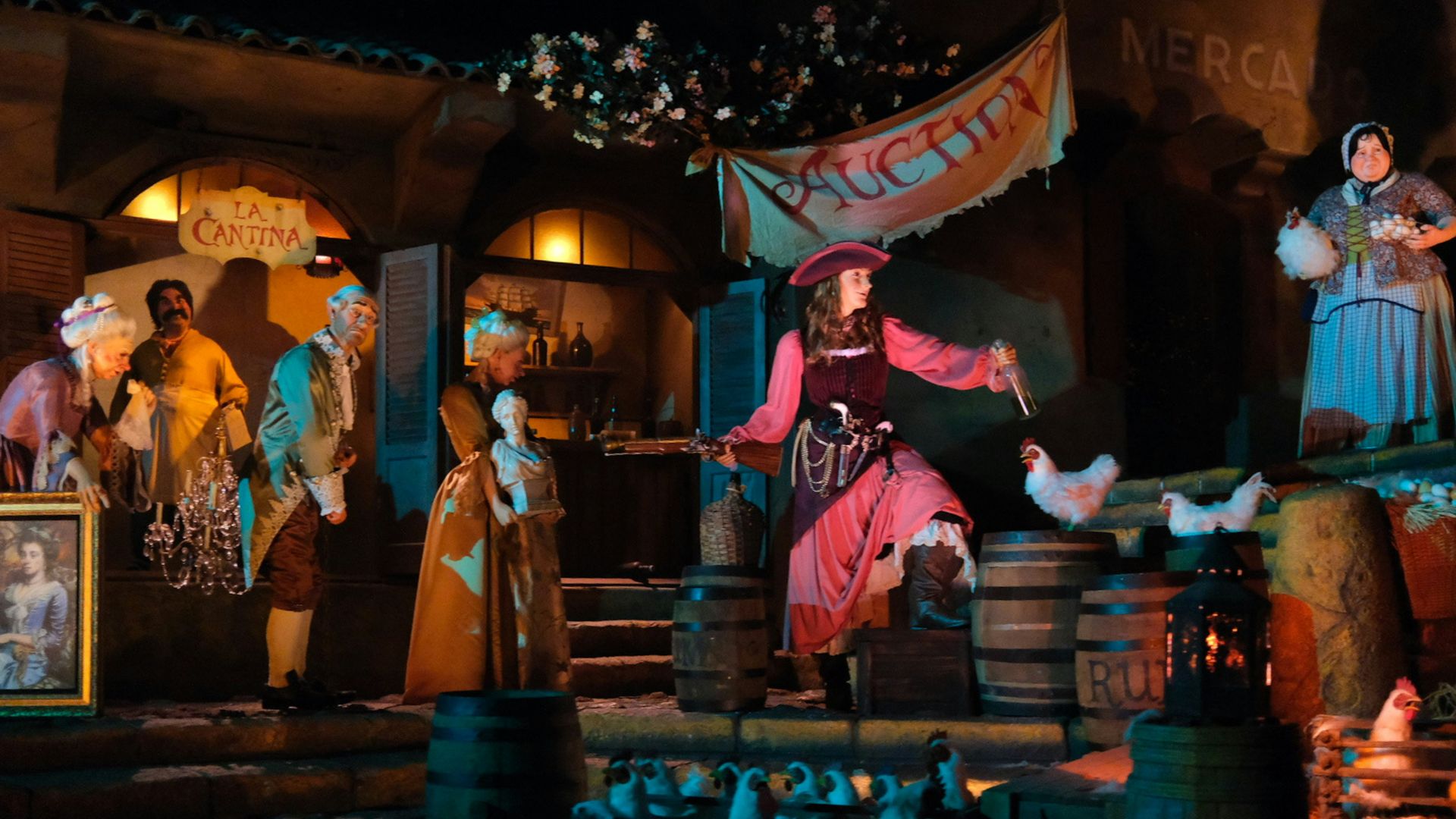Pirates of the Caribbean auction scene at Disneyland, featuring animatronics, pirates, and chickens in a dimly lit, immersive theme park ride setting.