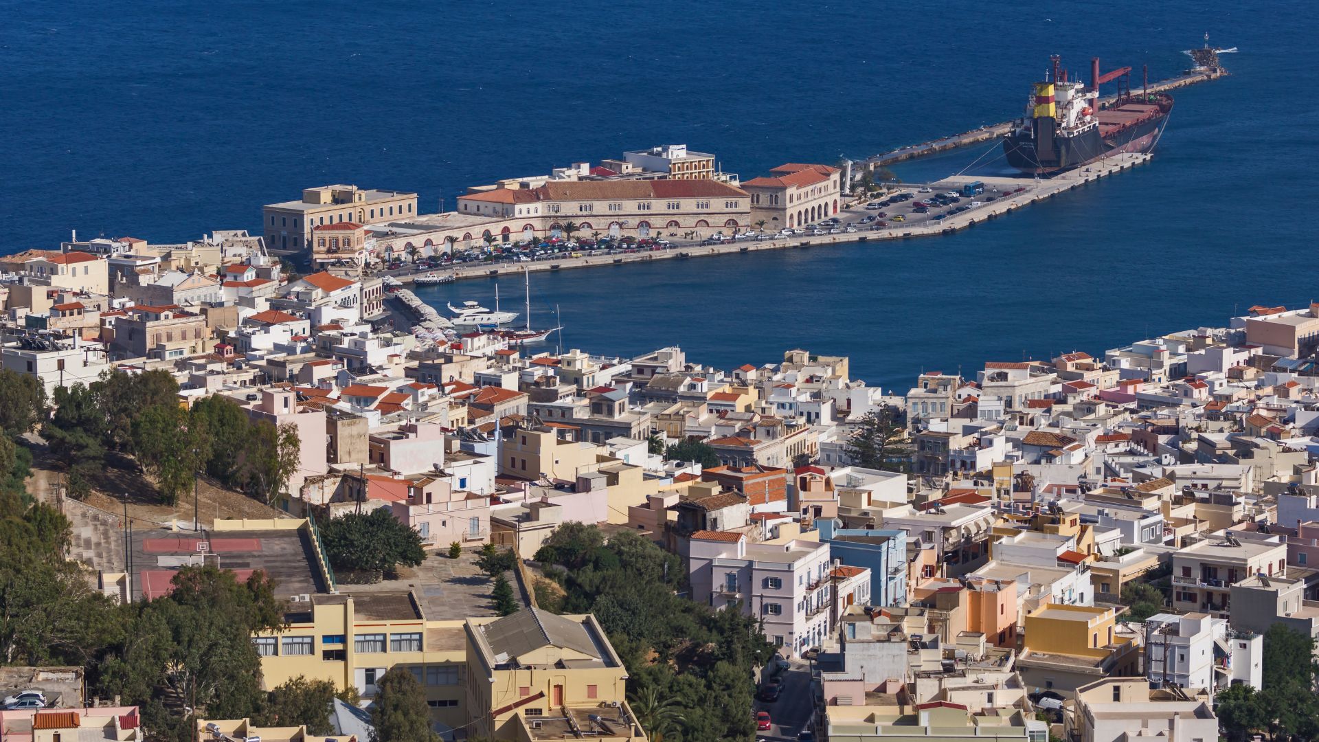 Aerial view of Ermoupoli port, Syros, Greece, showcasing neoclassical architecture and the Aegean Sea