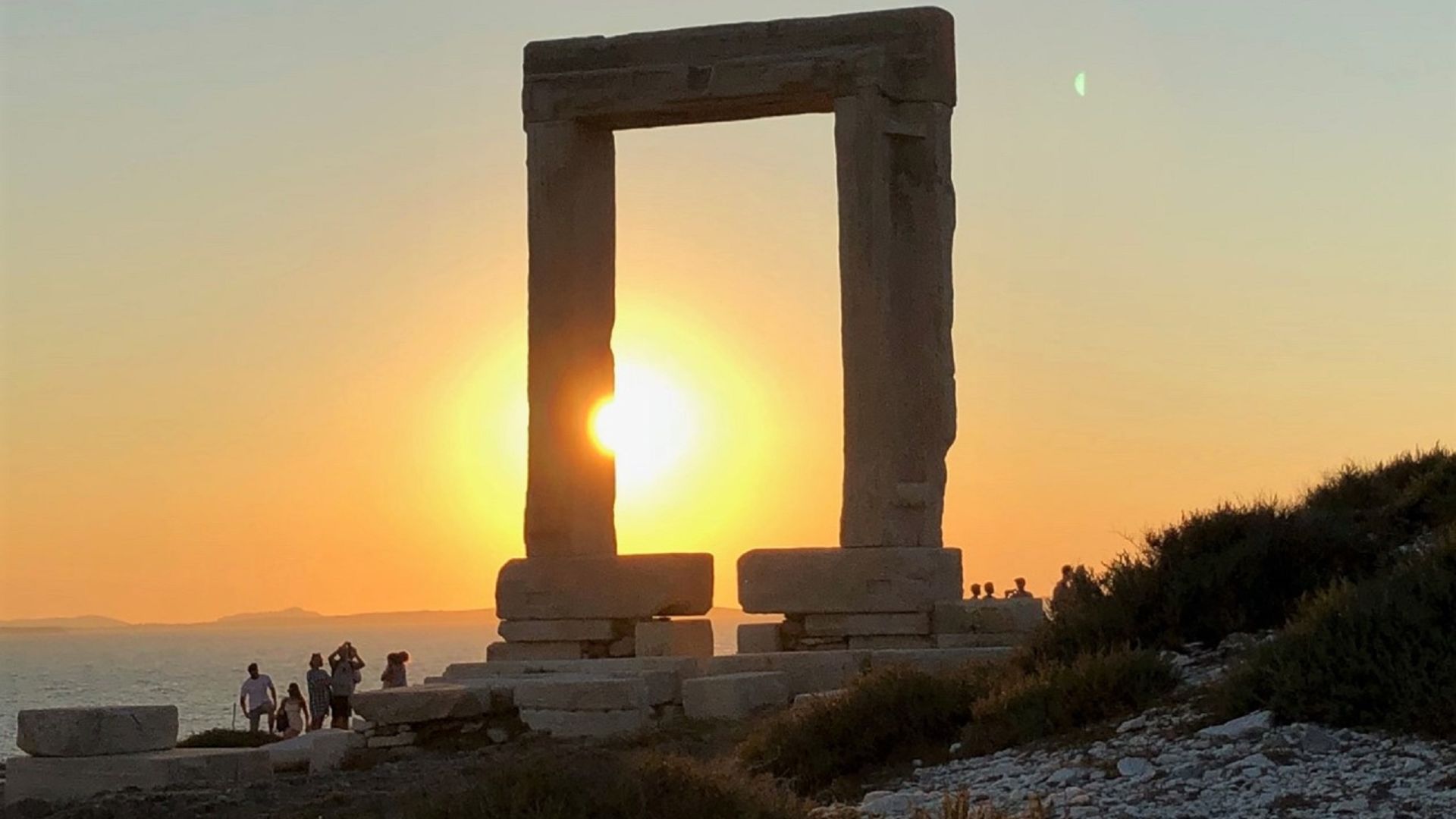 The massive marble gate of the Temple of Apollo on the islet of Palatia in Naxos, Greece. during sunset.