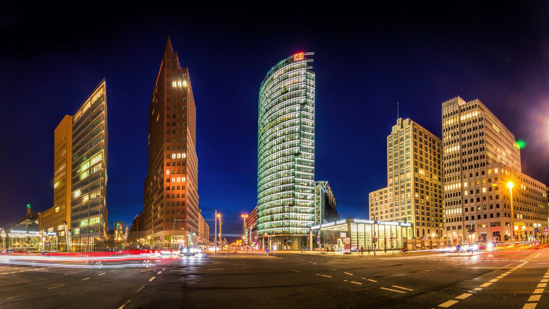 Nighttime scene with pedestrians under city lights at Potsdamer Platz