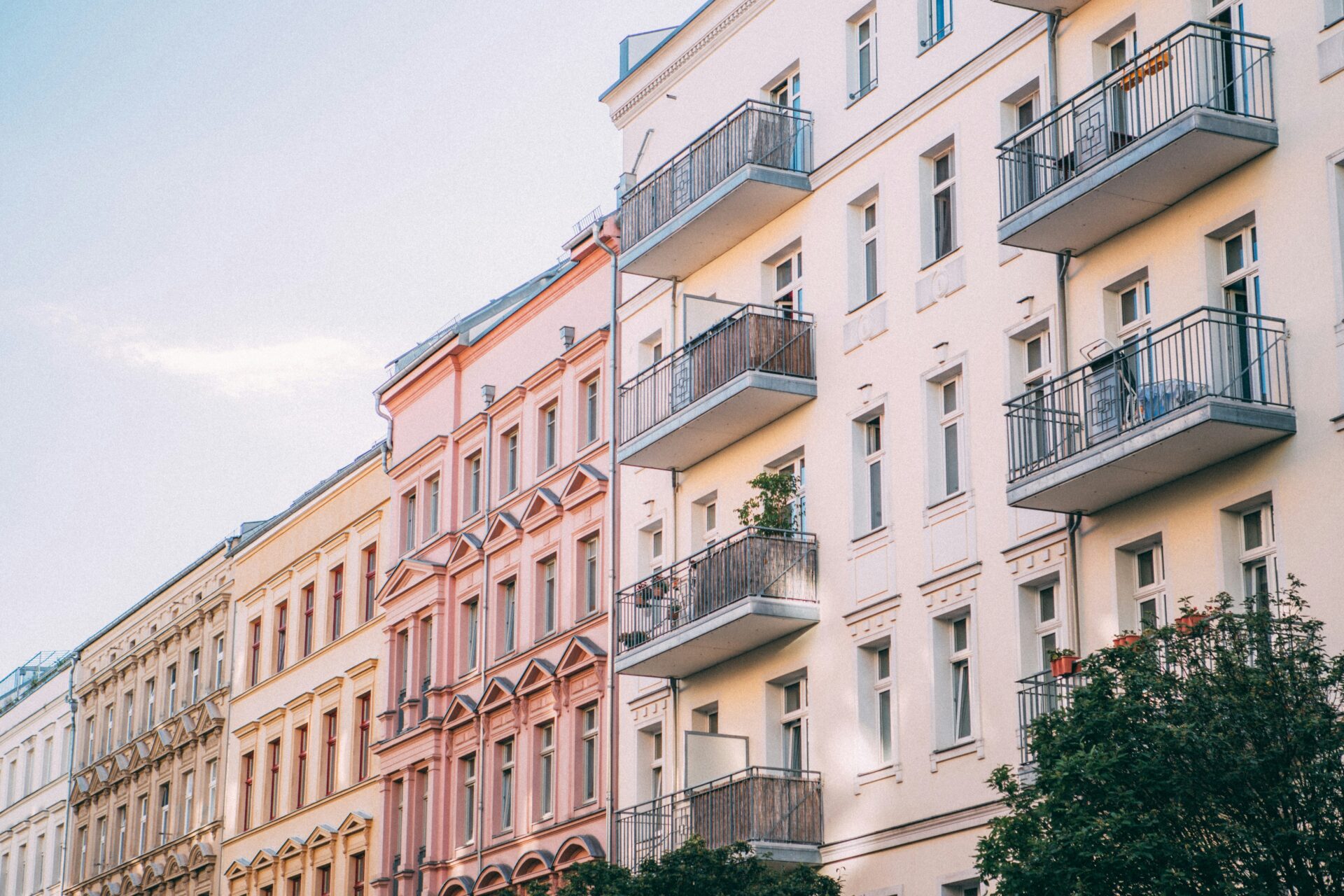 A row of pastel buildings with intricate details in Prenzlauer Berg