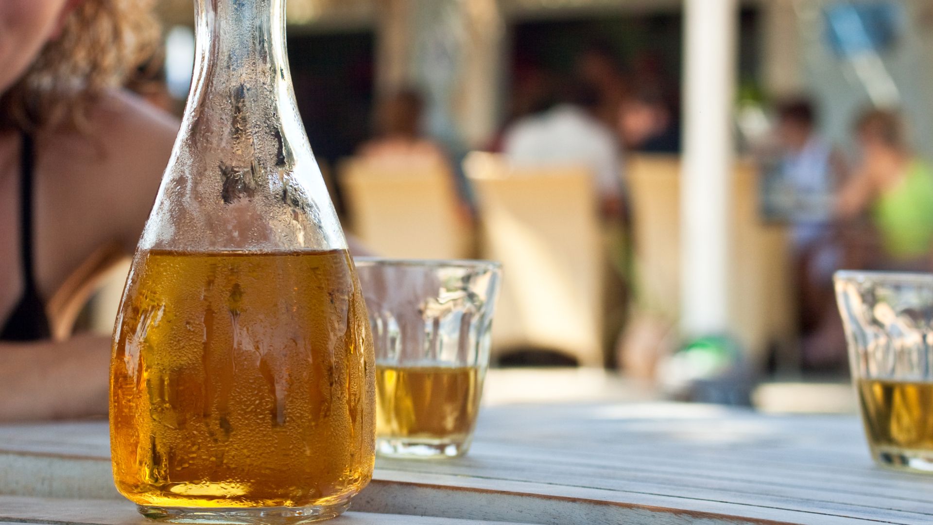 A bottle of Retsina and glass.