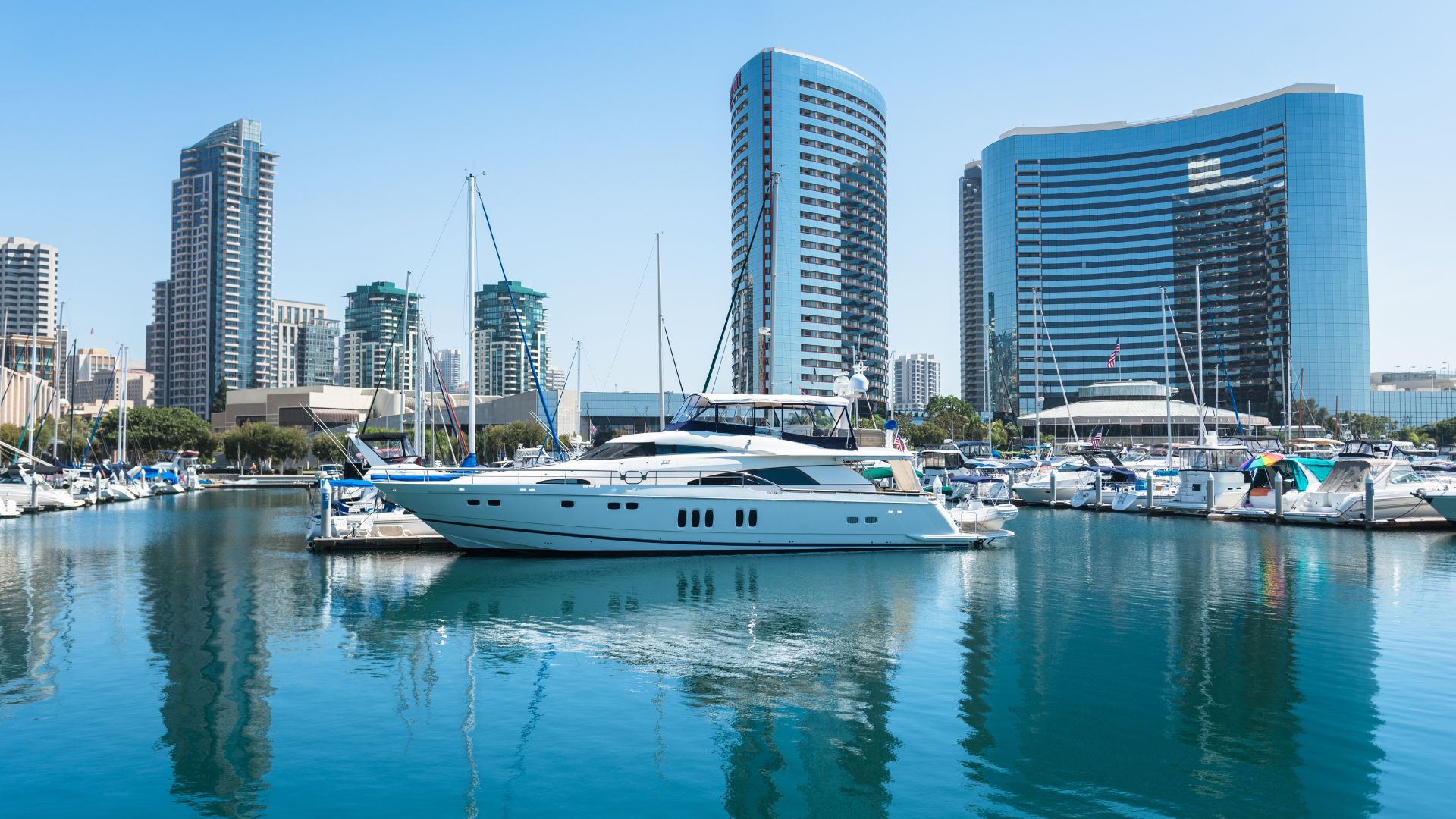 San Diego Bay waterfront with Marriott Marquis San Diego Marina and boats docked in the marina, showcasing the downtown San Diego skyline on a clear day.