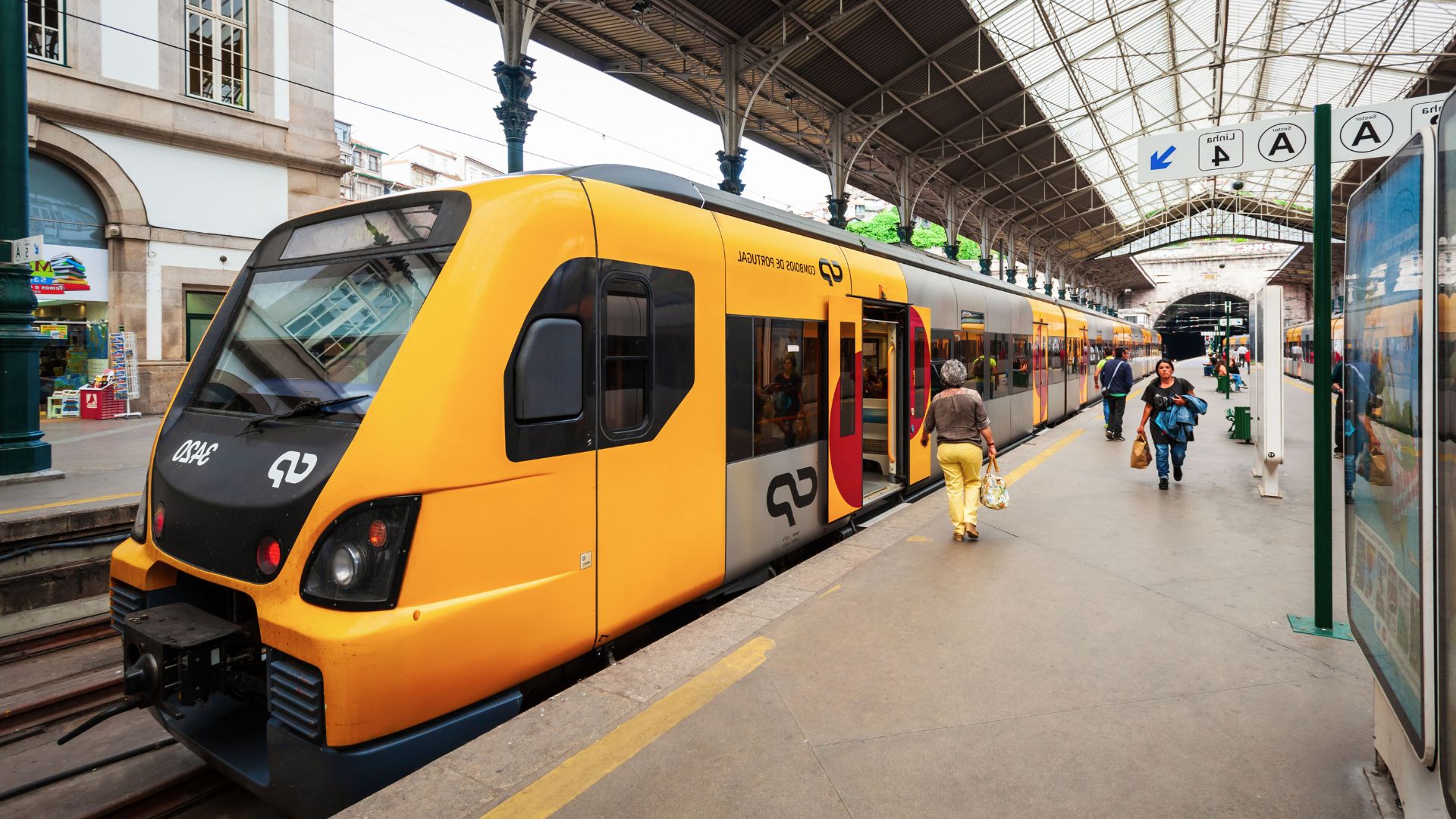 A yellow train at São Bento Railway Station in Porto, Portugal.