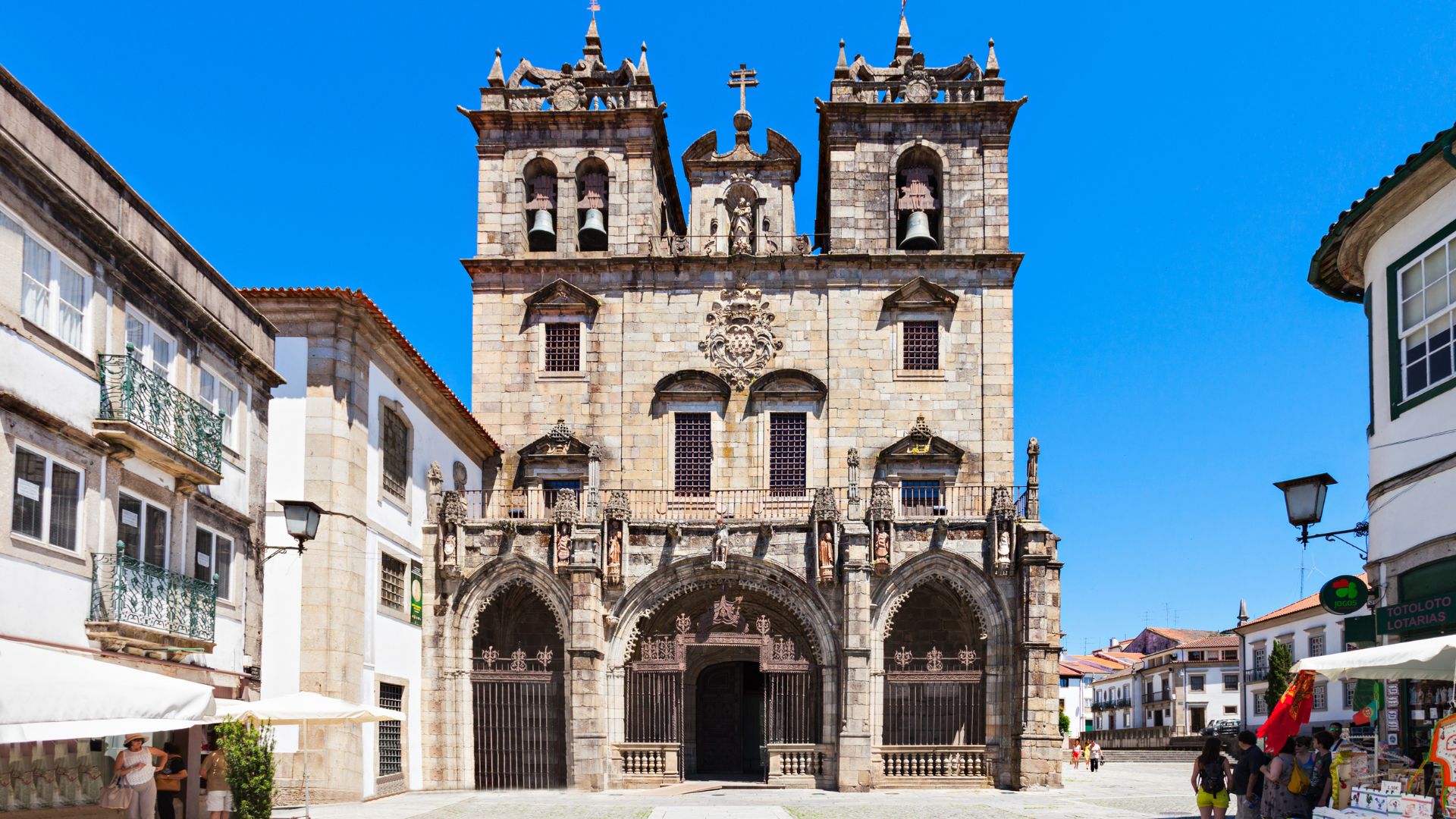 Braga Cathedral (Sé de Braga) in Braga, Portugal – historic Roman Catholic cathedral with ornate stone facade and bell towers under a clear blue sky.