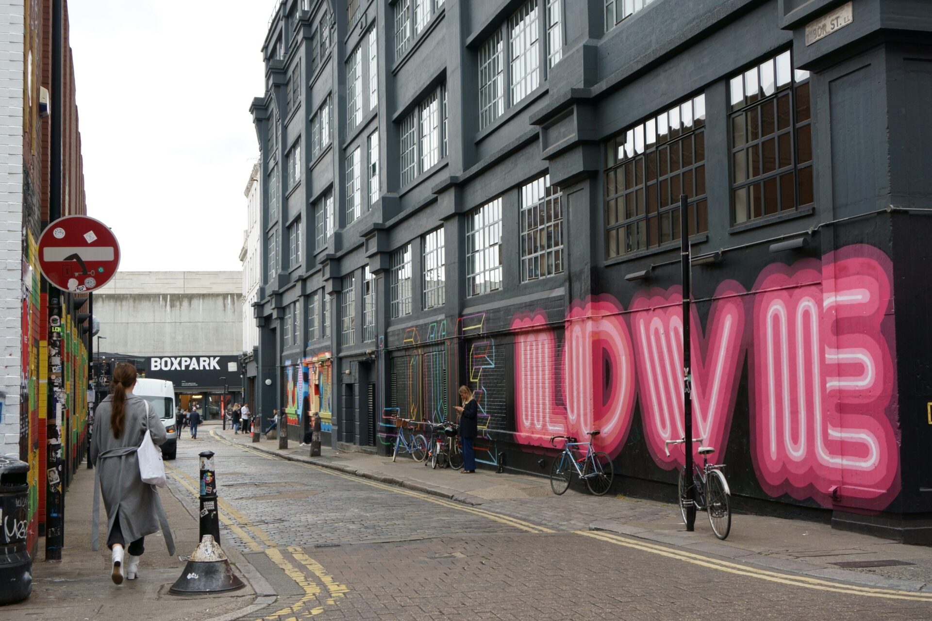 Shoreditch street with a wall covered in colorful graffiti art