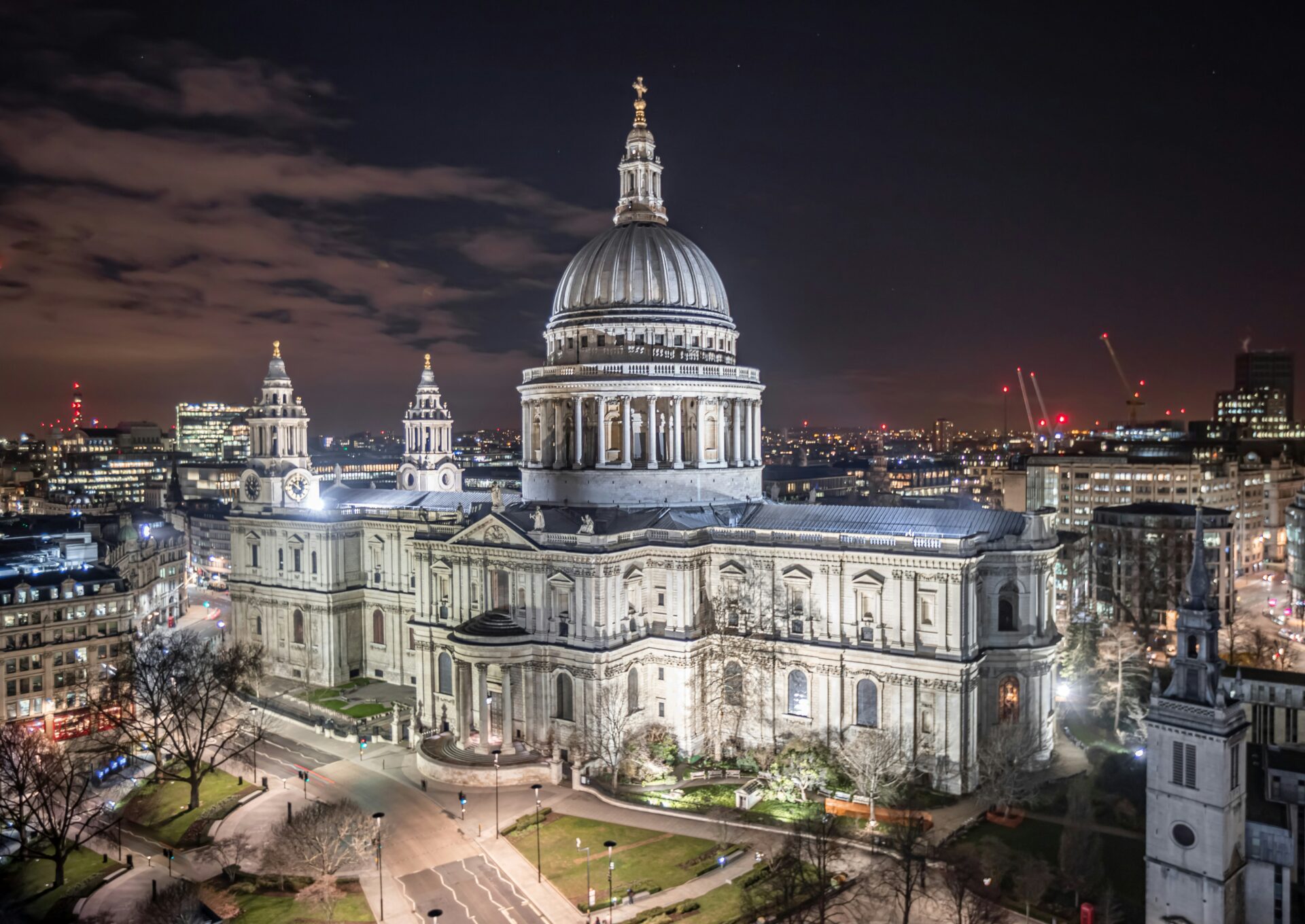 St. Paul’s Cathedral surrounded by modern cityscape at night