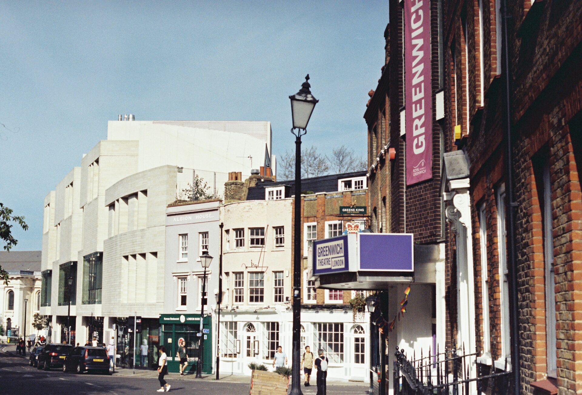Sunlit Greenwich street with vintage lampposts and Georgian facades
