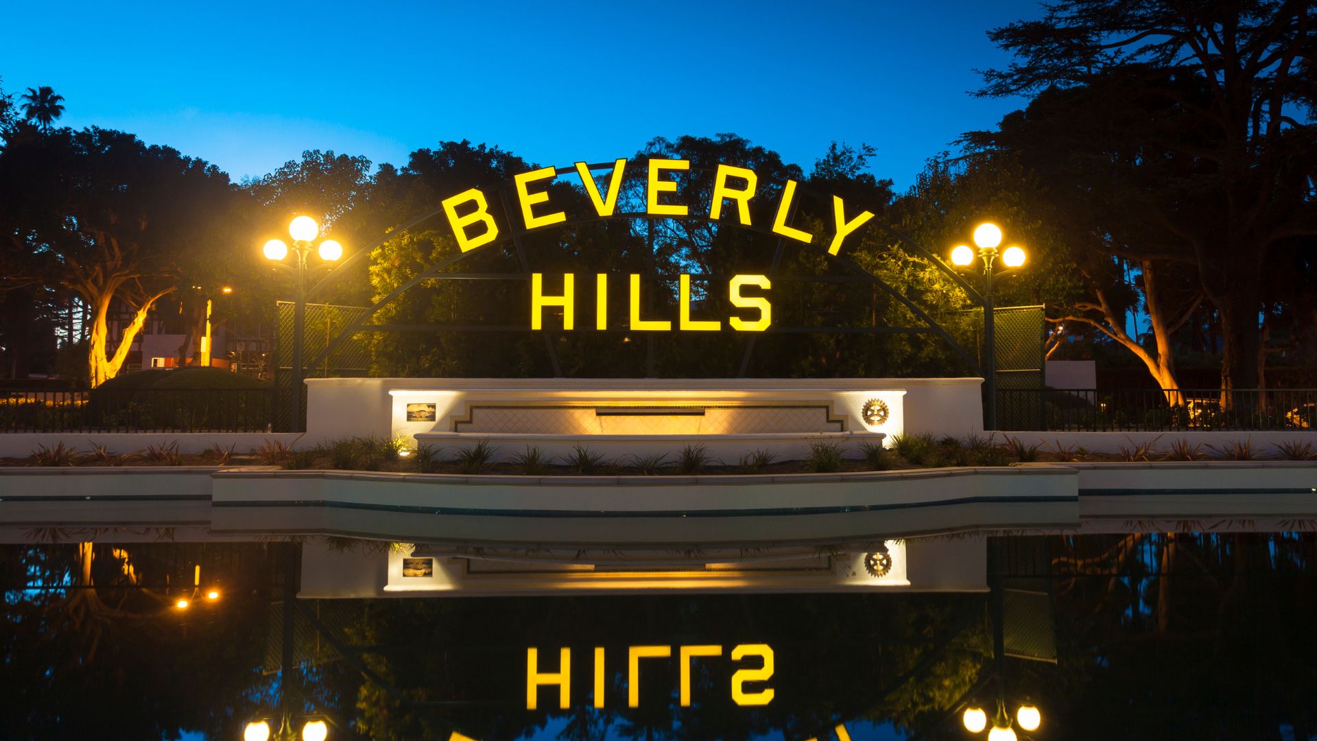 The iconic Beverly Hills sign lighted at night at Beverly Gardens Par