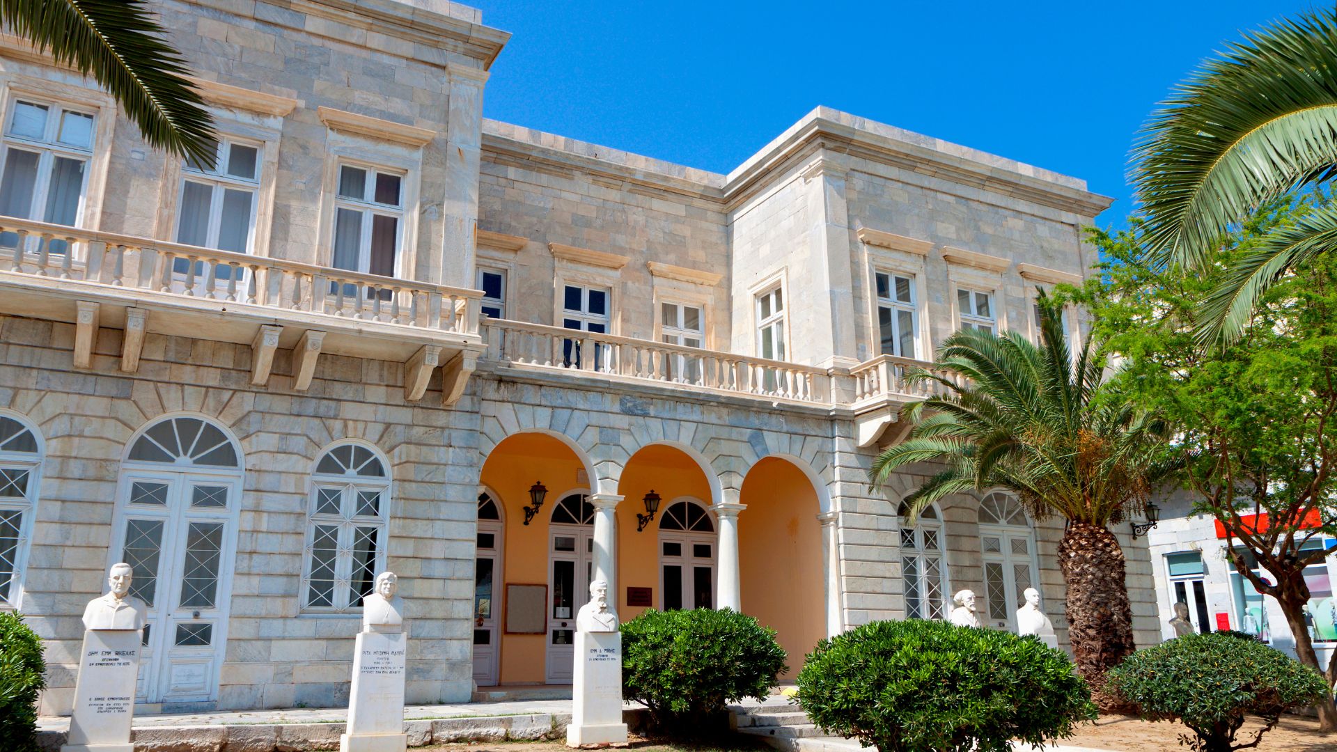 The Municipal Library of Ermoupoli, Syros, Greece, a neoclassical building with arched entrances and historical significance.