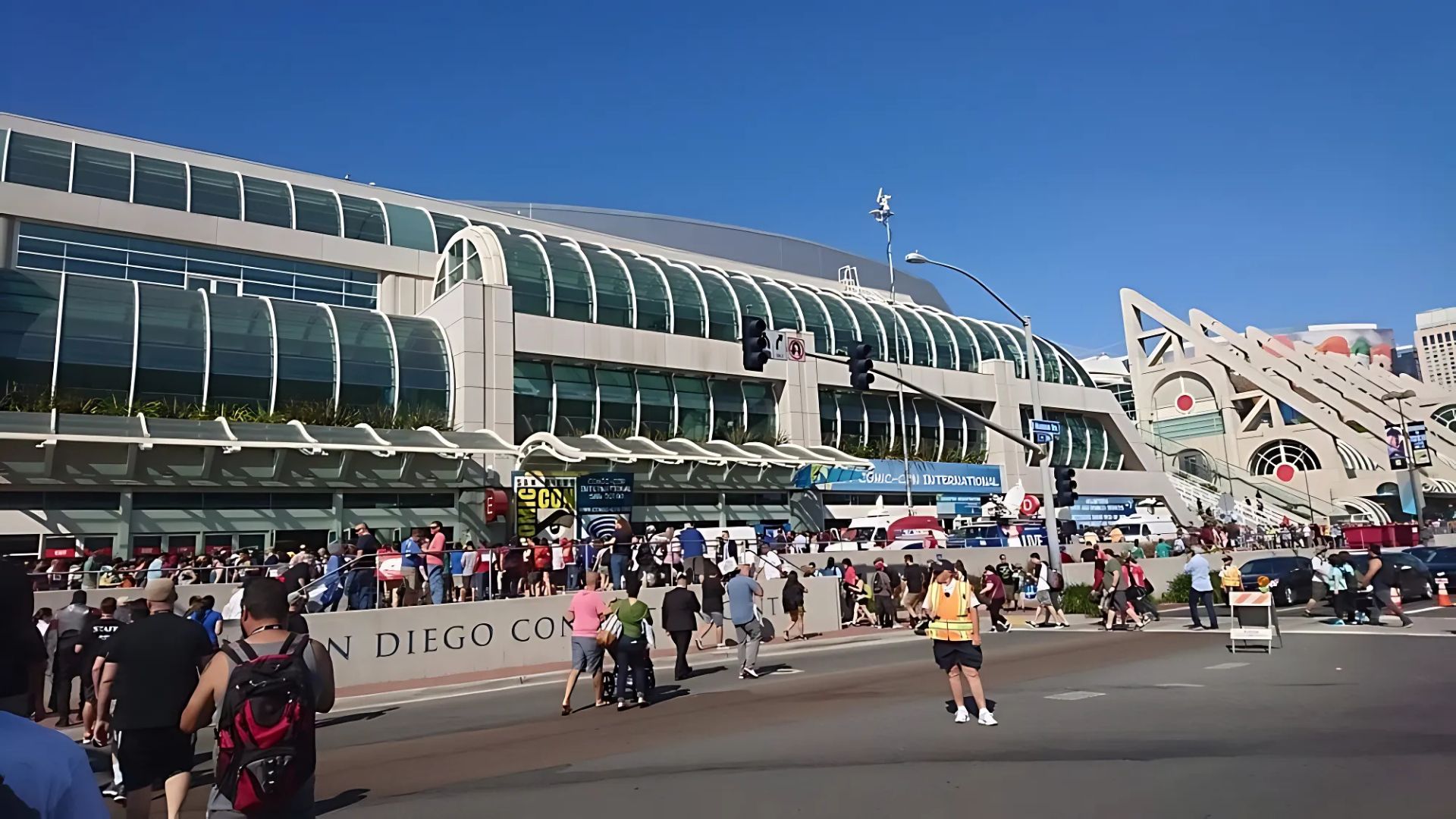 A wide shot of the San Diego Convention Center with a large crowd gathered outside, likely for an event such as Comic-Con International.