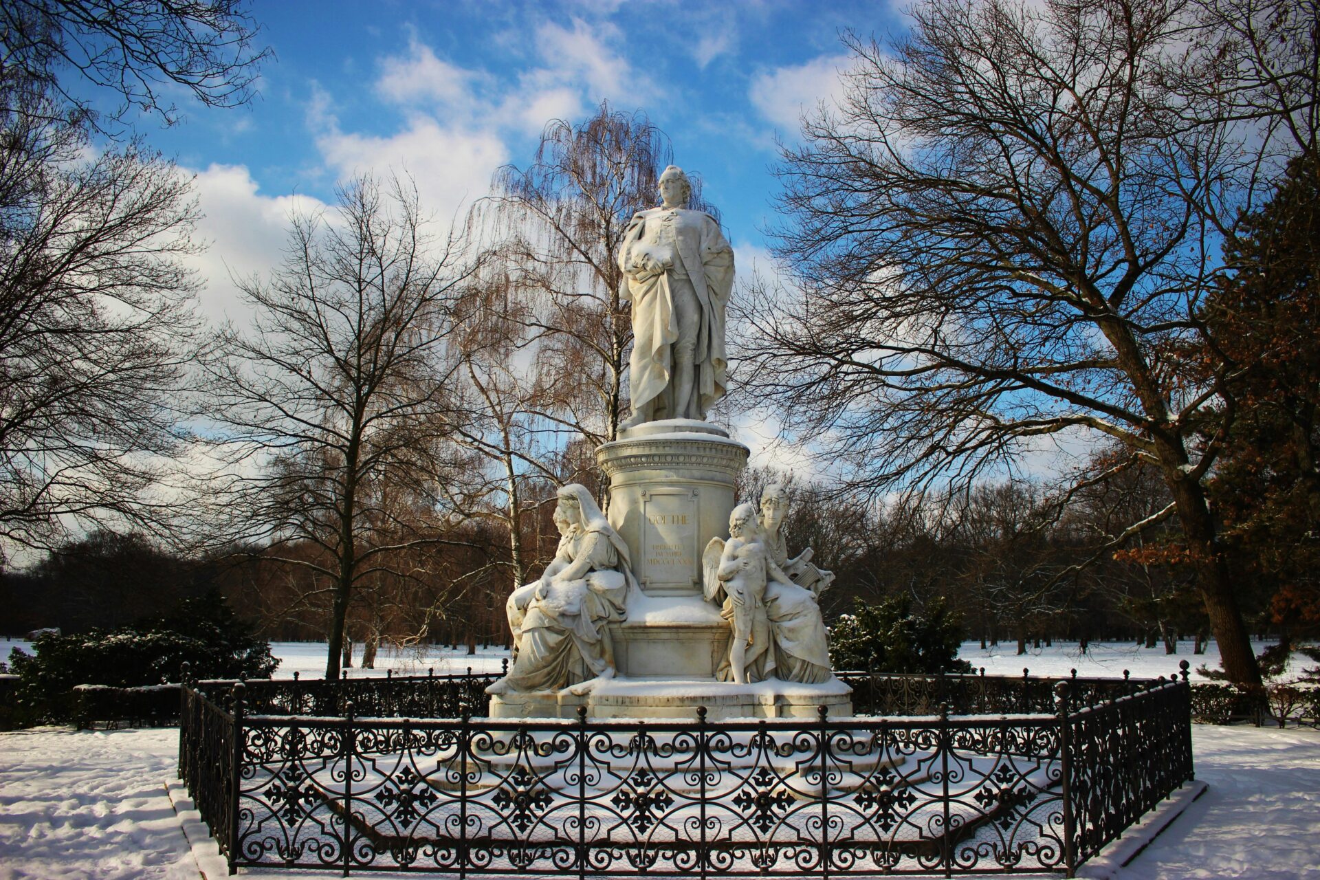 Marble statue of Johann Wolfgang von Goethe seated, surrounded by allegorical figures, in Berlin’s Tiergarten