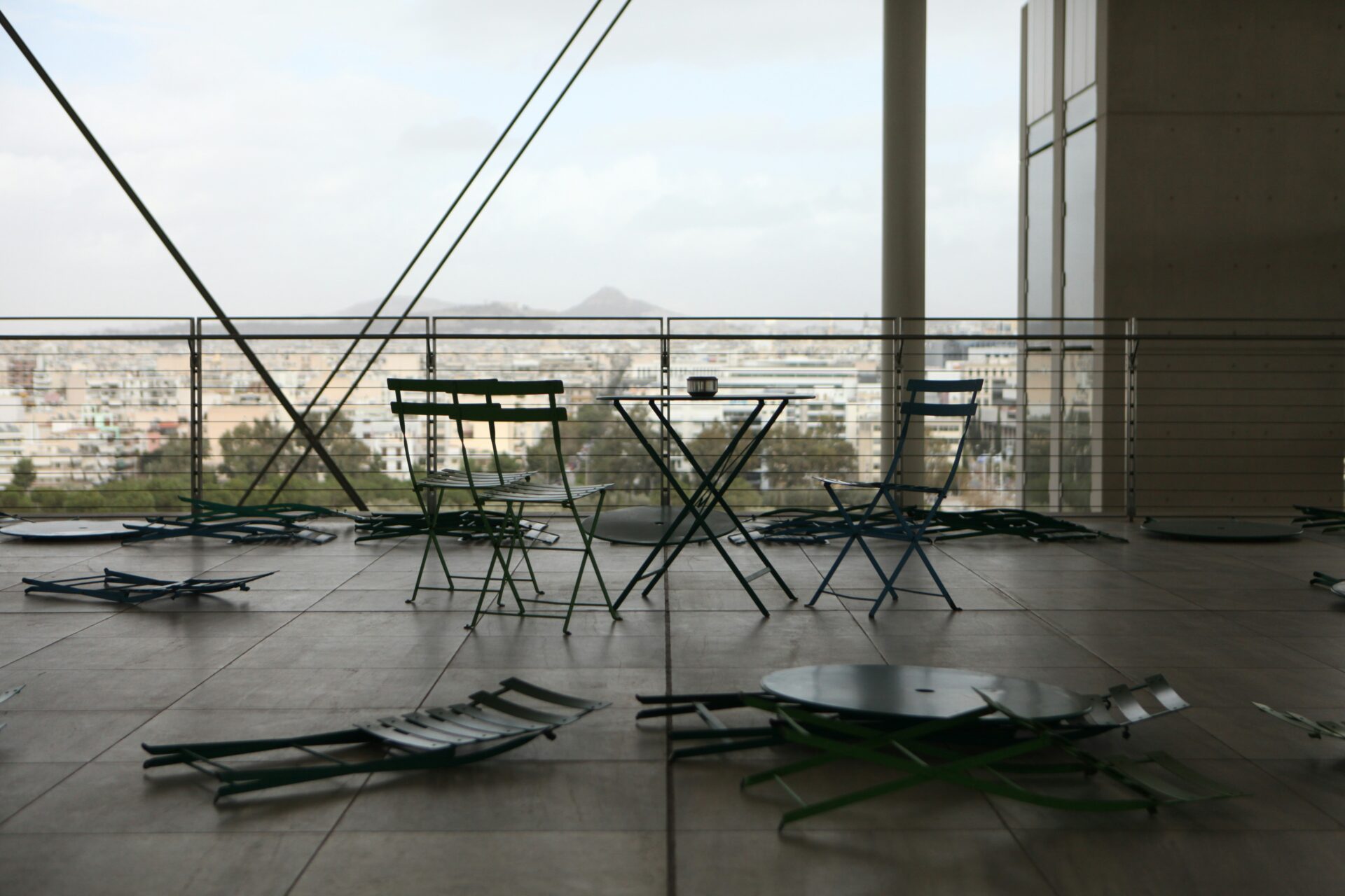 Stavros Niarchos Foundation Cultural Center - chairs and tables at the top floor of the building over-viewing the city