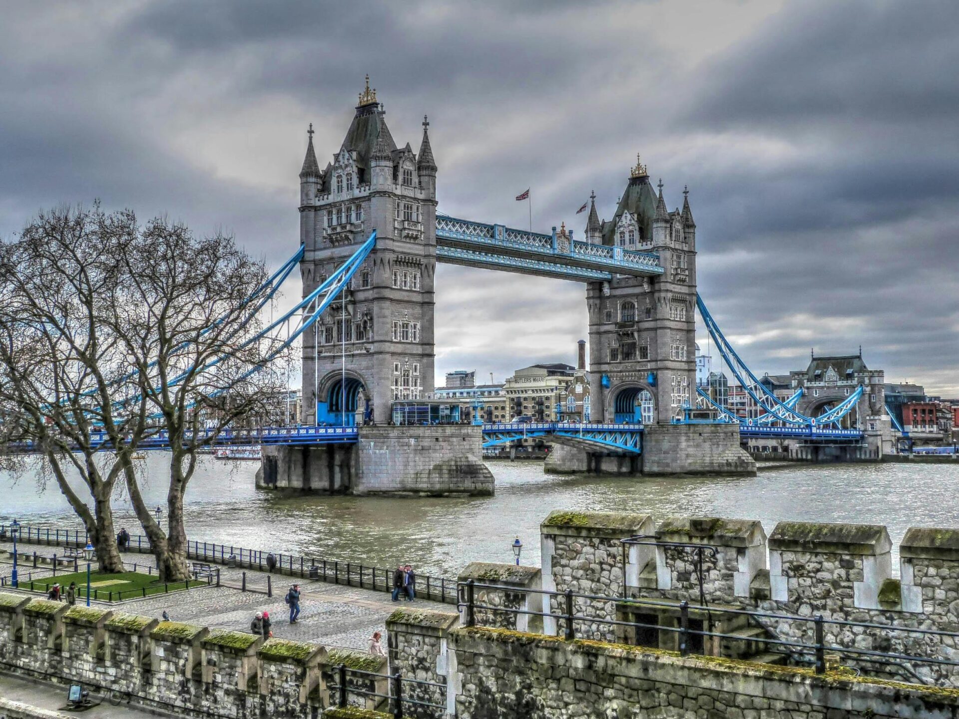 Tower Bridge under a moody, overcast sky, with the dark clouds contrasting against the bridge